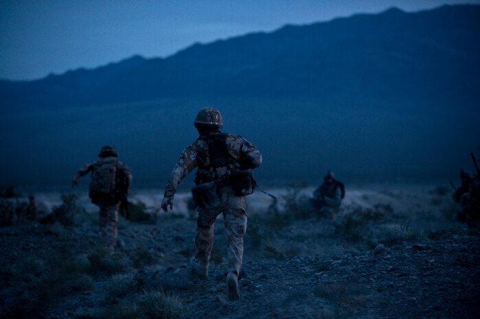 NEVADA TEST AND TRAINING RANGE -- Royal Air Force Airmen, from No.1 Squadron, Regiment 4 Force Protection Wing security forces, and U.S. Air Force Airmen from the 822nd Base Defense Squadron, Moody Air Force Base Ga., fall back to a new position while under attack during a field training exercise on the NTTR as part of exercise Desert Eagle March 16. Desert Eagle is integrated training between No. 1 Squadron, Royal Air Force Regiment and the 820th Base Defense Group from Moody Air Force Base, Ga., to improve both nations ability work together during present and future contingencies. (U.S. Air Force photo by Tech. Sgt. Michael R. Holzworth)