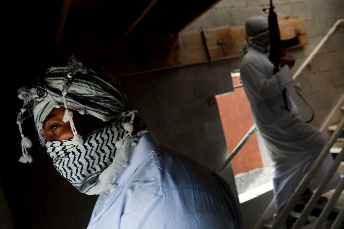 NEVADA TEST AND TRAINING RANGE -- Senior Airman Kenrick Mendez, 822nd Base Defense Squadron, Moody Air Force Base Ga., poses as an insurgent during a field training exercise on the NTTR as part of exercise Desert Eagle March 16. Desert Eagle is an integrated training between No. 1 Squadron, Royal Air Force Regiment and the 820th Base Defense Group from Moody Air Force Base, Ga., to improve both nations ability work together during present and future contingencies. (U.S. Air Force photo by Tech. Sgt. Michael R. Holzworth)