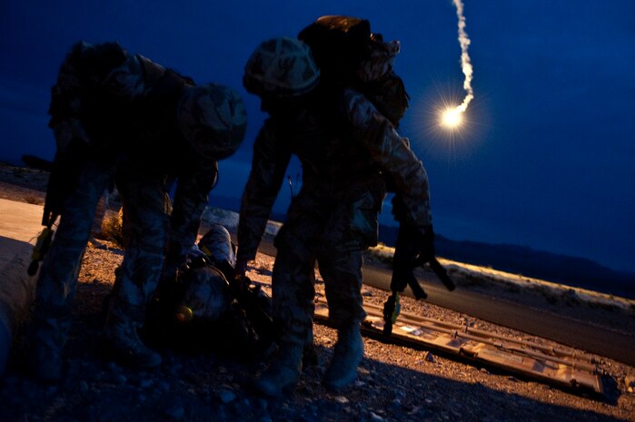 NEVADA TEST AND TRAINING RANGE -- Royal Air Force Airmen drag Senior Aircraftsman Chris Lott, No.1 Squadron, Regiment 4 Force Protection Wing security forces out of imminent danger after suffering a simulated sucking chest wound during a field training exercise on the NTTR as part of exercise Desert Eagle March 16.  Desert Eagle is an integrated training between No. 1 Squadron, Royal Air Force Regiment and the 820th Base Defense Group from Moody Air Force Base, Ga., to improve both nations ability work together during present and future contingencies. (U.S. Air Force photo by Tech. Sgt. Michael R. Holzworth)