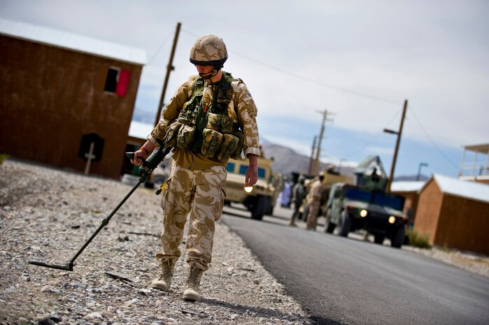 NEVADA TEST AND TRAINING RANGE -- Royal Air Force Senior Aircraftsman Adam Boots, No.1 Squadron, Regiment 4 Force Protection Wing security forces, sweeps for roadside bombs with a Vallon VMH3CS  in a mock Iraqi Village during a field training exercise at exercise Desert Eagle on the NTTR March 15. Desert Eagle is integrated training between No.1 Squadron, RAF Regiment and the 820th Base Defense Group Moody Air Force Base Ga., to improve both nations ability to work together during present and future contingencies. (U.S. Air Force photo by Airman 1st Class George Goslin)