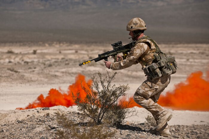 NEVADA TEST AND TRAINING RANGE -- Royal Air Force Cpl. Daniel Hopla No. 1 Squadron, Regiment 4 Force Protection Wing security forces advances toward suspected insurgents during a field training exercise on the NTTR as part of exercise Desert Eagle March 14. Desert Eagle is an integrated training between No. 1 Squadron, Royal Air Force Regiment and the 820th Base Defense Group from Moody Air Force Base, Ga., to improve both nations ability work together during present and future contingencies. (U.S. Air Force photo by Tech. Sgt. Michael R. Holzworth)