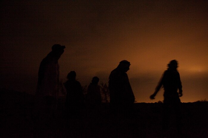 NEVADA TEST AND TRAINING RANGE -- Airmen from the 822nd Base Defense Squadron, Moody Air Force Base Ga., and Royal Air Force No. 1 Squadron, Regiment 4 Force Protection Wing security forces posing as insurgents prepare to launch simulated mortars during a field training exercise on the NTTR as part of exercise Desert Eagle March 14. Desert Eagle is an integrated training between No. 1 Squadron, Royal Air Force Regiment and the 820th Base Defense Group from Moody Air Force Base, Ga., to improve both nations ability work together during present and future contingencies. (U.S. Air Force photo by Tech. Sgt. Michael R. Holzworth)