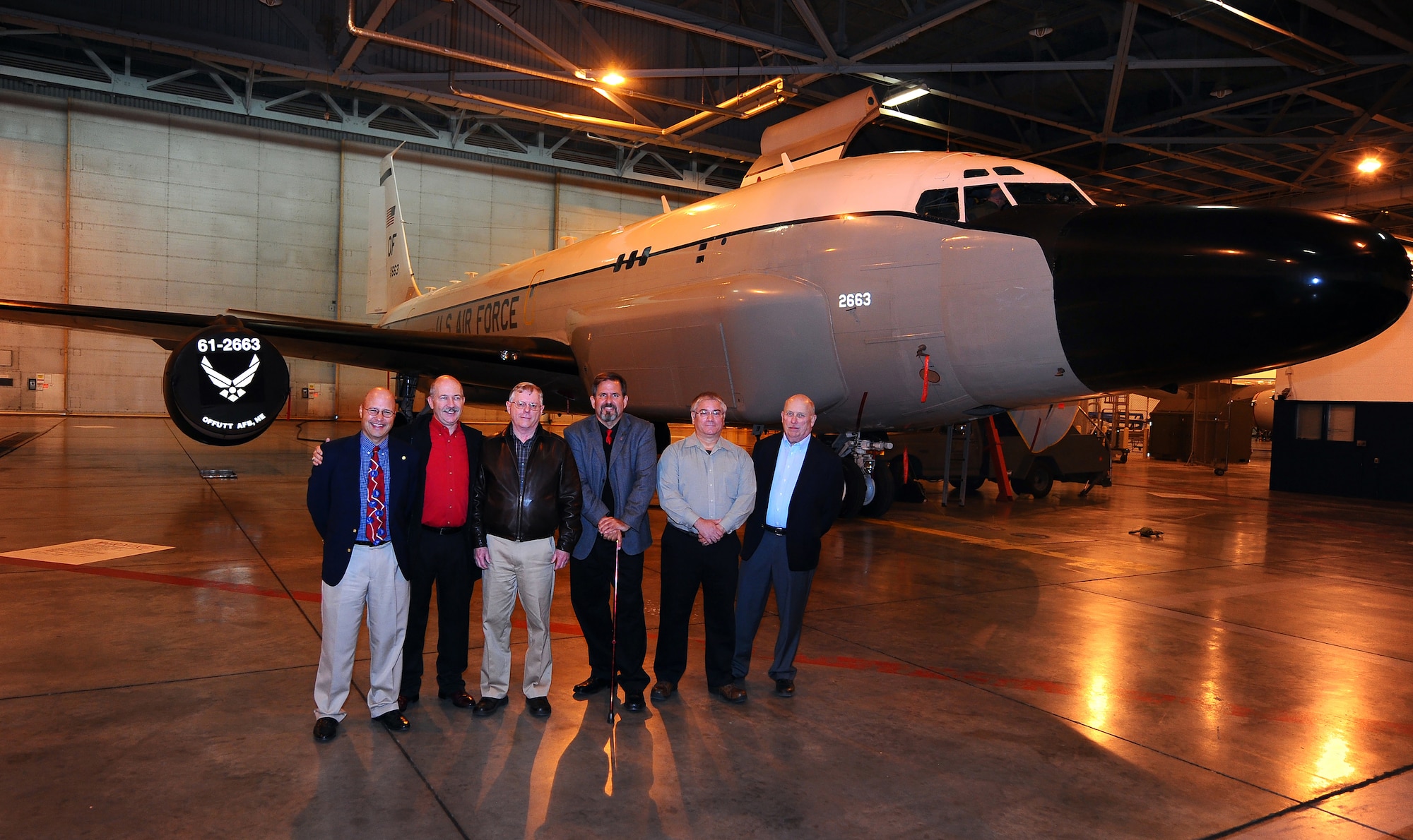 OFFUTT AIR FORCE BASE, Neb. - Thirty years to the day that Cobra Ball 61-2664 crashed upon landing in severe weather at Shemya Air Force Base, Alaska, taking the lives of six crew members, six survivors of the stand side by side in front of a modern day Cobra Ball aircraft located in Dock 1 of Offutt's Bennie Davis Maintenance Facility here March 15. Friends and family of the surviving crew members were here for a memorial service at the 45th Reconnaissance Squadron headquarters, where a memorial stands to those who made the ultimate sacrifice. U.S. Air Force Photo by Josh Plueger (released)