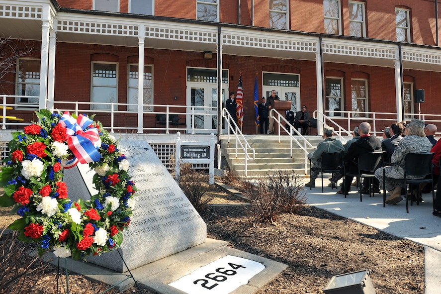 OFFUTT AIR FORCE BASE, Neb. - A memorial to the six crew members of Cobra Ball 61-2664 that lost their lives when their aircraft crashed upon landing in severe weather at Shemya Air Force Base, Alaska, resides outside the 45th Reconnaissance Squadron headquarters here as crash survivor Bill Maxwell addresses attendees at the 30th anniversary memorial service of the crash March 15. Friends and family of the surviving crew members attended the service and toured a Cobra Ball static display to mark the occasion. U.S. Air Force Photo by Charles Haymond