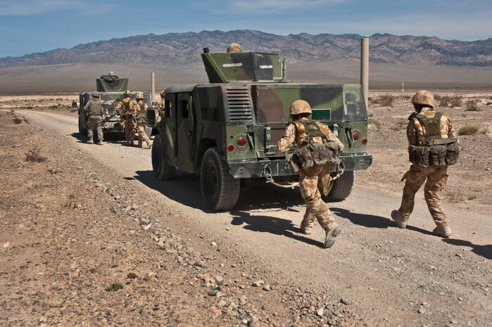 NEVADA TEST AND TRAINING RANGE -- Airmen from the 822nd Base Defense Squadron, Moody Air Force Base Ga., and Royal Air Force No. 1 Squadron, Regiment 4 Force Protection Wing security forces personnel use HUMVEE's as cover to advance toward a suspected insurgents during a field training exercise on the NTTR as part of exercise Desert Eagle March 14. Desert Eagle is an integrated training between No. 1 Squadron, Royal Air Force Regiment and the 820th Base Defense Group from Moody AFB, to improve both nations ability work together during present and future contingencies. (U.S. Air Force photo by Tech. Sgt. Michael R. Holzworth)