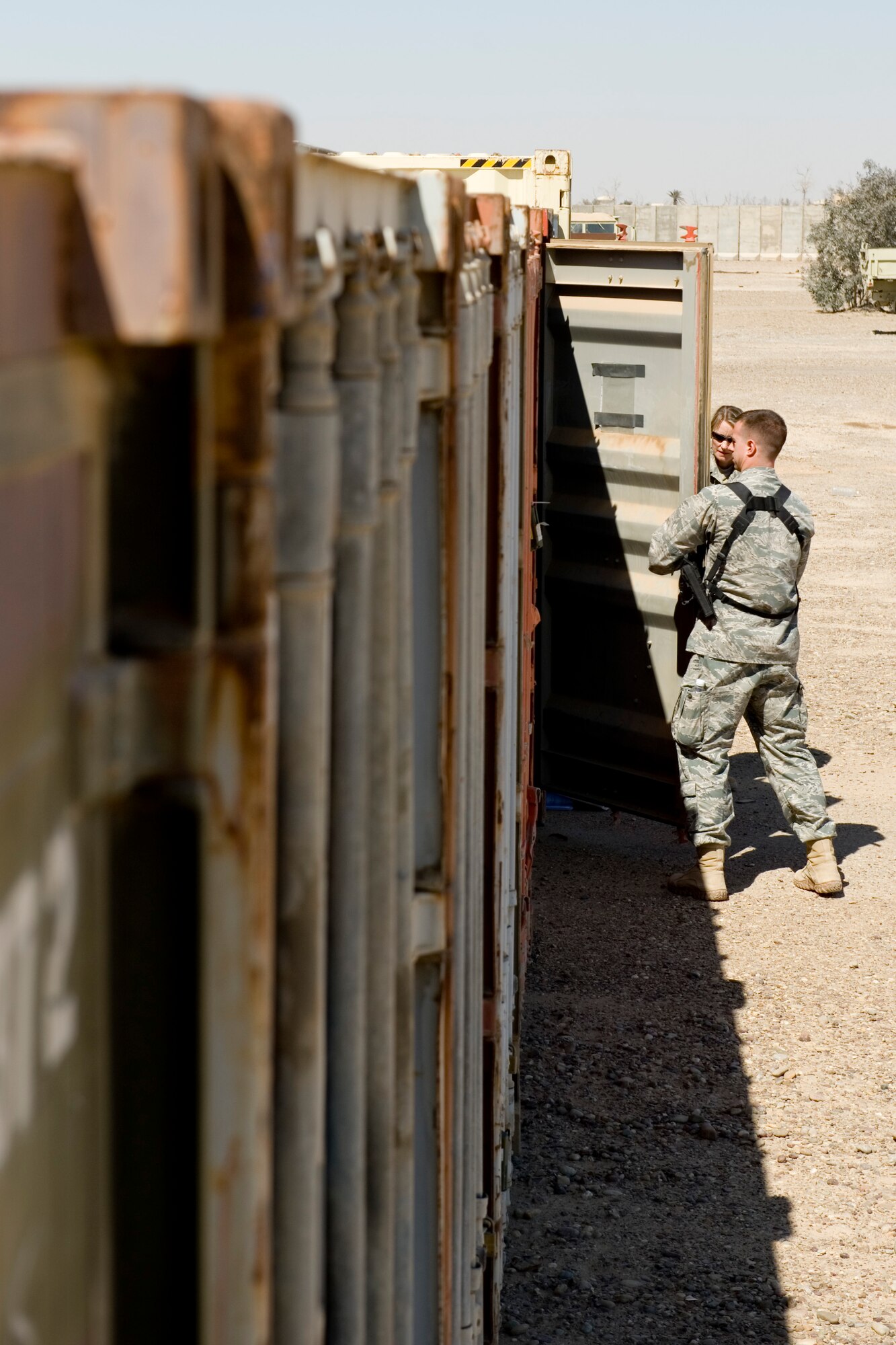 TIKRIT, Iraq -- 2nd Lt. John Ouellet III, Iraq Training and Advisory Mission-Air officer in charge of the foreign excess personal property program, opens a container to inspect its contents before transfer to the Iraqi military March 17. The transfer, involving five crates and more than $300,000 of equipment, is part of more than $7 million in assets being transferred in order to save money on shipping costs and strengthen the U.S. partnership with Iraq. Lieutenant Ouellet is deployed from the 60th Aerial Port Squadron, Travis Air Force Base, Calif., and is a native of Los Gatos, Calif. (U.S. Air Force photo by Staff Sgt. Levi Riendeau)