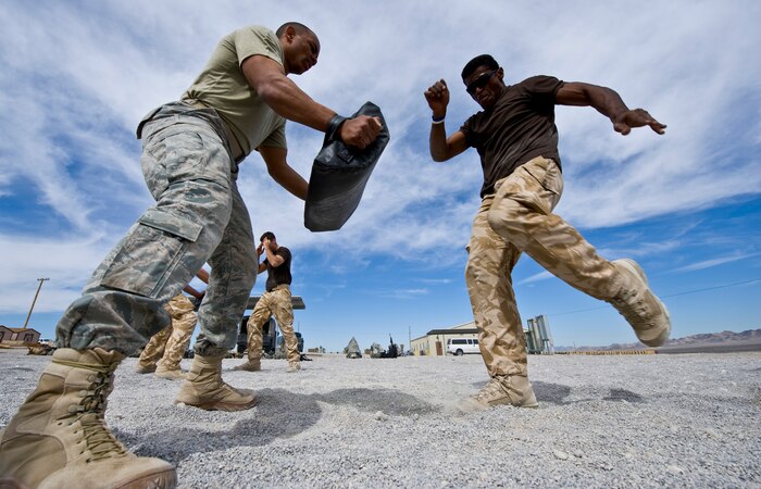 NEVADA TEST AND TRAINING RANGE -- 1st Lt. Ralph Johnson, 822nd Base Defense Squadron security forces, Moody Air Force Base, Ga., and SAC Tevita Ratuvuki, Regiment 4 Force Protection Wing security forces practice Krav Maga martial arts during Exercise Desert Eagle March 10. Desert Eagle is a tactics, techniques, and procedures exchange to conduct training at the squadron, flight andfire team levels to prepare for combined deployed operations.  The integrated training between two allied nations will improve their ability to work together during present and future contingencies. (U.S. Air Force photo by Airman 1st Class George Goslin)