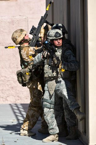 NEVADA TEST AND TRAINING RANGE -- Service members of the U.S. Air Force 820th Base Defense Group and the Royal Air Force, No. 1 Squadron stack up in preparation for building clearing during exercise Desert Eagle on the Nevada Test and Training Range March 9. Exercise Desert Eagle is integrated training between No. 1 Squadron, RAF Regiment and the 820th Base Defense Group from Moody Air Force Base, Ga., to improve both nations ability work together during present and future contingencies. (U.S. Air Force photo by Senior Airman Brett Clashman)