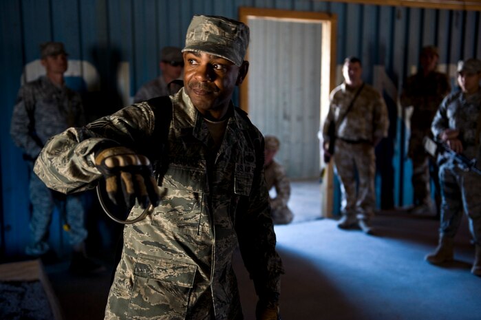 NEVADA TEST AND TRAINING RANGE -- Staff Sgt. Avonte Seabrooks, 820th Base Defense Group, Moody Air Force Base Ga., explains building clearing tactics during exercise Desert Eagle March 9. Exercise Desert Eagle is integrated training between No. 1 Squadron, RAF Regiment and the 820th Base Defense Group from Moody Air Force Base, Ga., to improve both nations ability work together during present and future contingencies. (U.S. Air Force photo by Senior Airman Brett Clashman)