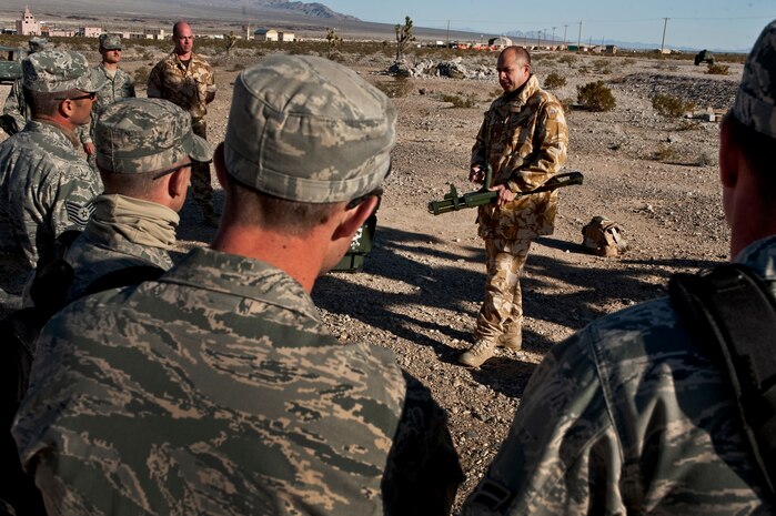 NEVADA TEST AND TRAINING RANGE -- Royal Air Force Sgt. Hugh Perminter, No. 1 Squadron, Regiment 4 Force Protection Wing security forces, holds a Vallon VMH3CS Improvised Explosive Device finder while training U.S. Air Force Airmen from during exercise Desert Eagle  March 8. Desert Eagle is integrated training between No. 1 Squadron, RAF Regiment and the 820th Base Defense Group from Moody Air Force Base, Ga.,  to improve both nations ability work together during present and future contingencies. (U.S. Air Force photo by Tech Sgt. Michael R. Holzworth)