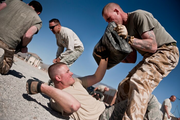 NEVADA TEST AND TRAINING RANGE -- Royal Air Force Senior Aircraftsman Neil Morgan, No. 1 Squadron, Regiment 4 Force Protection Wing security forces, holds a pad as U.S. Air Force Staff Sgt. Patrick Steele, 820th Base Defense Squadron, Moody Air Force Base Ga., practices Krav Maga during a training class at exercise Desert Eagle March 8. Desert Eagle is an integrated training between No. 1 Squadron, RAF Regiment and the 820th Base Defense Group from Moody Air Force Base, Ga., to improve both nations ability work together during present and future contingencies. (U.S. Air Force photo by Tech Sgt. Michael R. Holzworth)