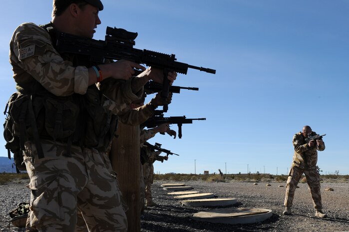 NEVADA TEST AND TRAINING RANGE -- Royal Air Force Sgt. Andreas Hall, No. 1 Squadron, Regiment 4 Force Protection Wing security forces weapons instructor, shows RAF Airman the proper shooting position before firing on the shooting range during exercise Desert Eagle on the Nevada Test and Training Range March 8. Desert Eagle is integrated training between No. 1 Squadron, Royal Air Force Regiment and the 820th Base Defense Group from Moody Air Force Base, Ga., to improve both nations ability work together during present and future contingencies. (U.S. Air Force photo by Airman1st Class Daniel Hughes)