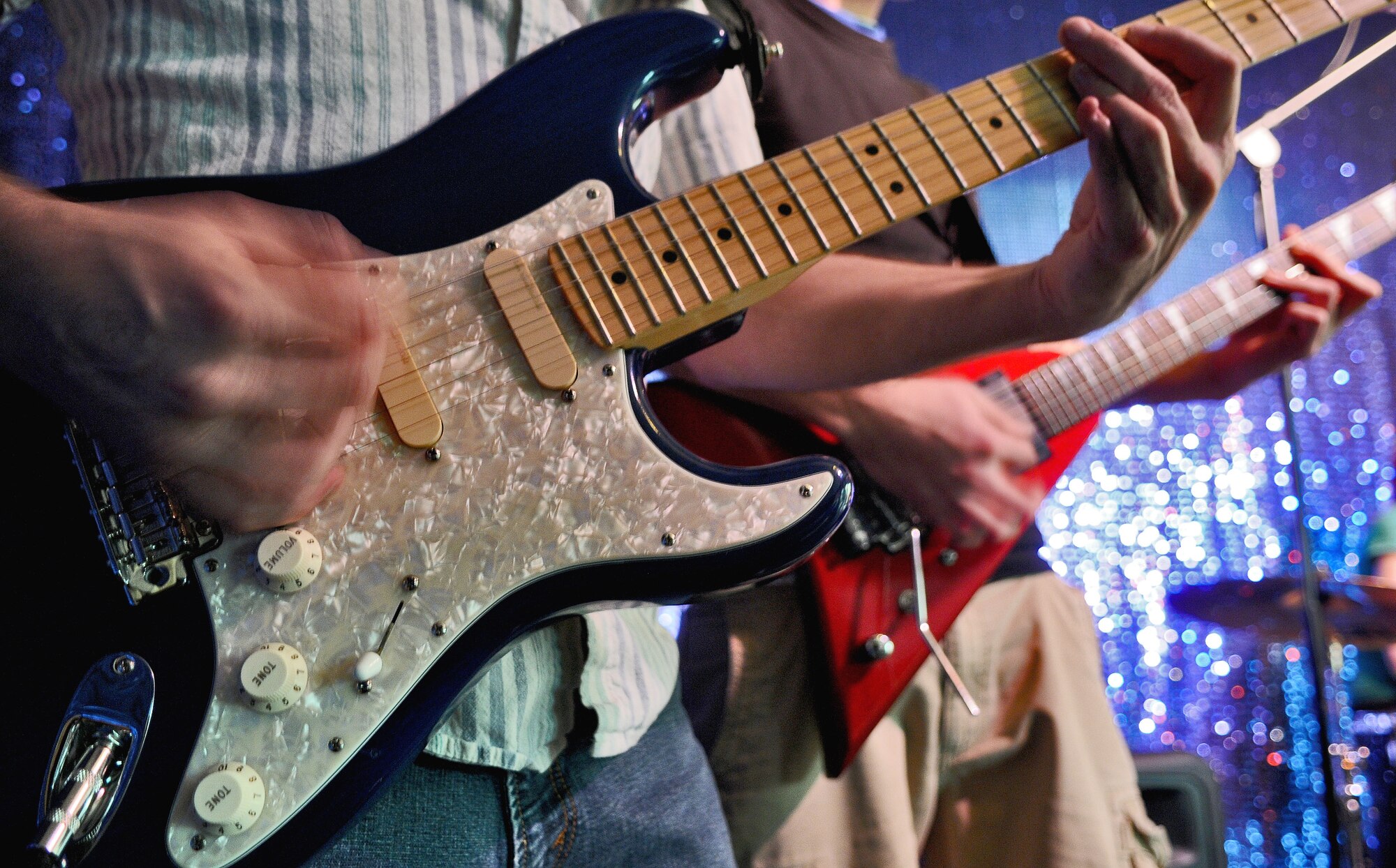 SPANGDAHLEM AIR BASE, Germany – Members from the 52nd Fighter Wing play electric guitars in the Brick House’s music studio March 11. The studio officially opened on March 3 and has electric guitars, a drum set, a keyboard and recording equipment available to all base members 18 years and older from noon - 8 p.m. Monday through Saturday. (U.S. Air Force photo/Senior Airman Nick Wilson) 