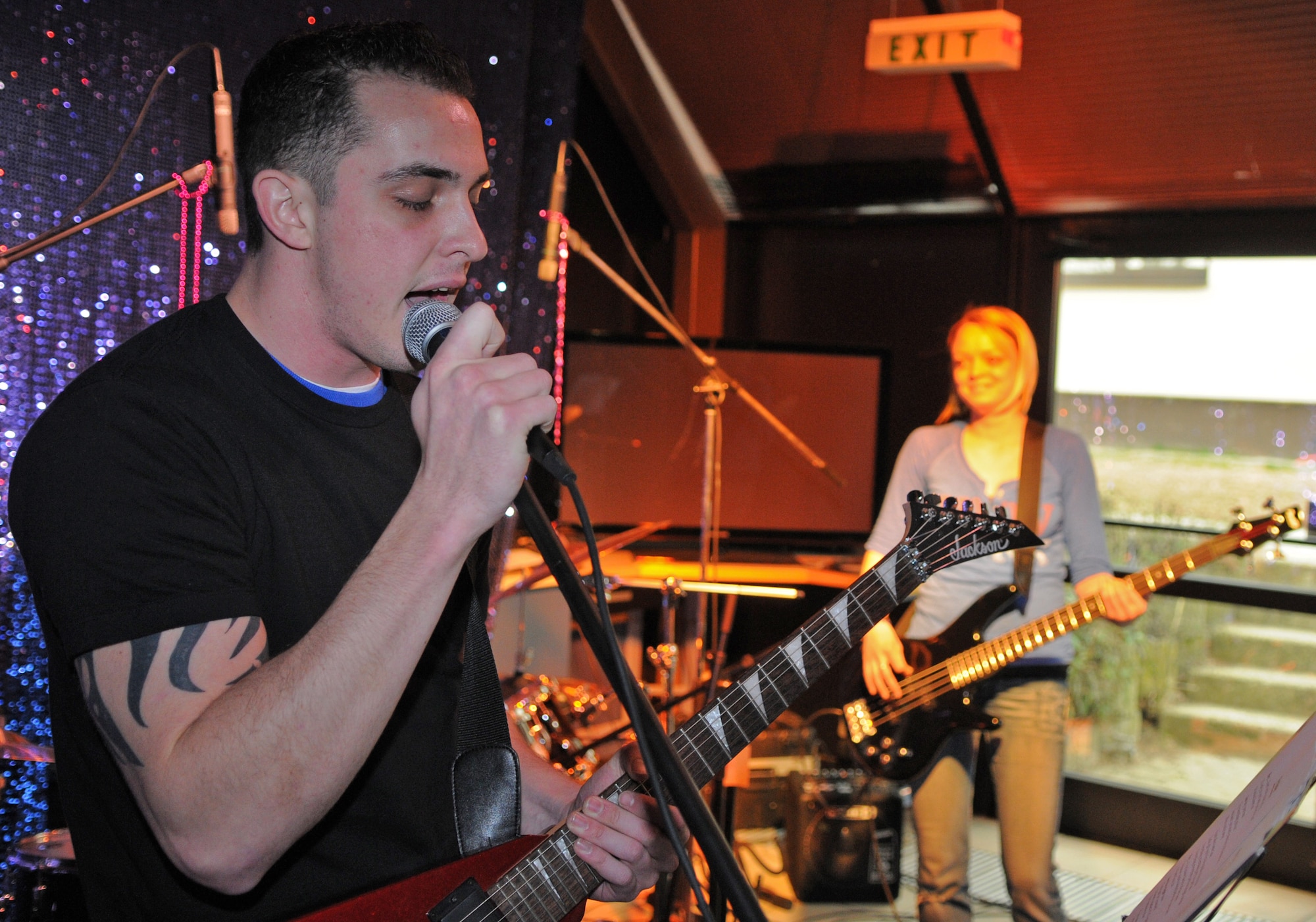 SPANGDAHLEM AIR BASE, Germany – Airman 1st Class Curtis Duke, 52nd Security Forces Squadron patrolman, sings a contemporary rock song while playing the electric guitar in the Brick House’s music studio March 11. The studio officially opened on March3 and is open to all base members older than 18 from noon - 8 p.m. Monday through Saturday. (U.S. Air Force photo/Senior Airman Nick Wilson) 