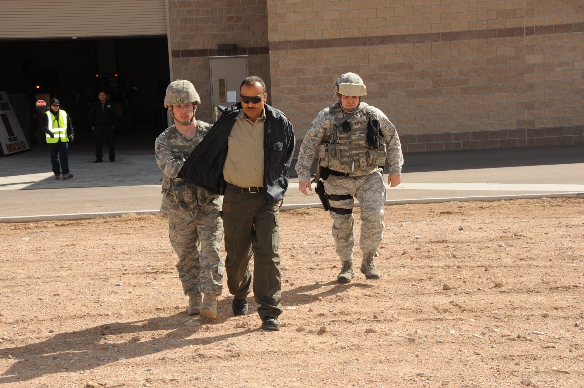 Security Forces Airmen bring out a “suspect” during a suspicious package exercise.  U.S. Air Force  Photo by Dennis Carlson