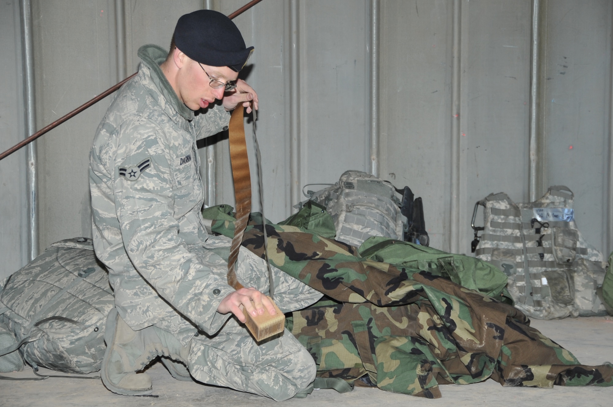 Airman 1st Class Bryce Darragh checks his gear as his unit exercises deployment operations at Coyote Canyon.  U.S. Air Force  Photo by Todd Berenger