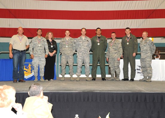 The 58th Special Operations Wing annual award winners are, left, Allen Roos, Category IV Civilian of the Year, Master Sgt. Alexis Arturet, Senior Noncommissioned Officer of the Year, Tiffany Mitton, Joan Orr Air Force Spouse of the Year, Staff Sgt. Aaron Nelson, Kirtland Air Force Base Honor Guard Member of the Year, Col. James Cardoso, commander, Tech. Sgt. Mitchell Melendez, Volunteer of the Year, Capt. Kyle Bailey, Company Grade Officer of the Year, Maj. Caleb Nimmo, Field Grade Officer of the Year, and Chief Master Sgt. Richard Wilk, command chief.  U.S. Air Force Photo by Dennis Carlson