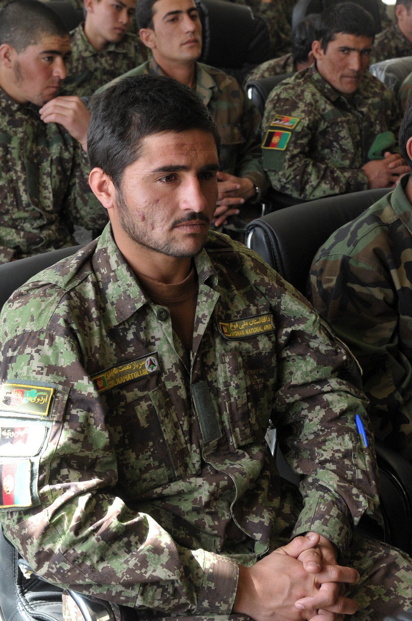 KABUL, Afghanistan - Member of the Afghan Air Force waits to be called up to receive his graduation certificate from the Pohantoon-e-Hawayee, The Afghan Air Force's "Big Air School", on the Afghan Air Force base in Kabul, Afghanistan March 17. (U.S. Navy photo by Mass Communications Specialist 3rd Class Jared E. Walker)
