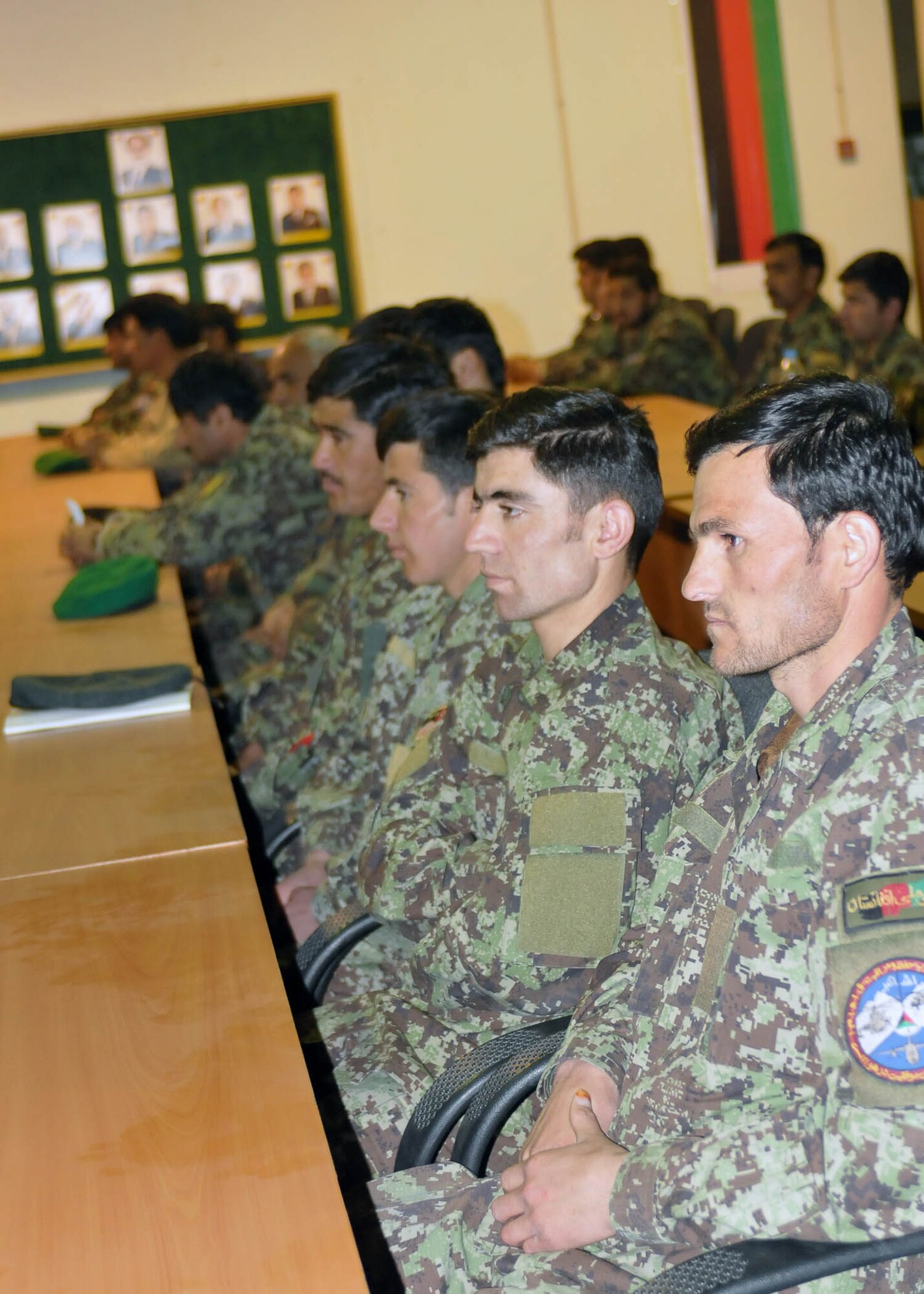 KABUL, Afghanistan - Airman in the Afghan Air Force wait to be presented with gifts by their superiors in the Afghan Air Force at the Afghan Air Force base in Kabul, Afghanistan, March 19. (U.S. Navy photo by Mass Communications Specialist 3rd Class Jared E. Walker).