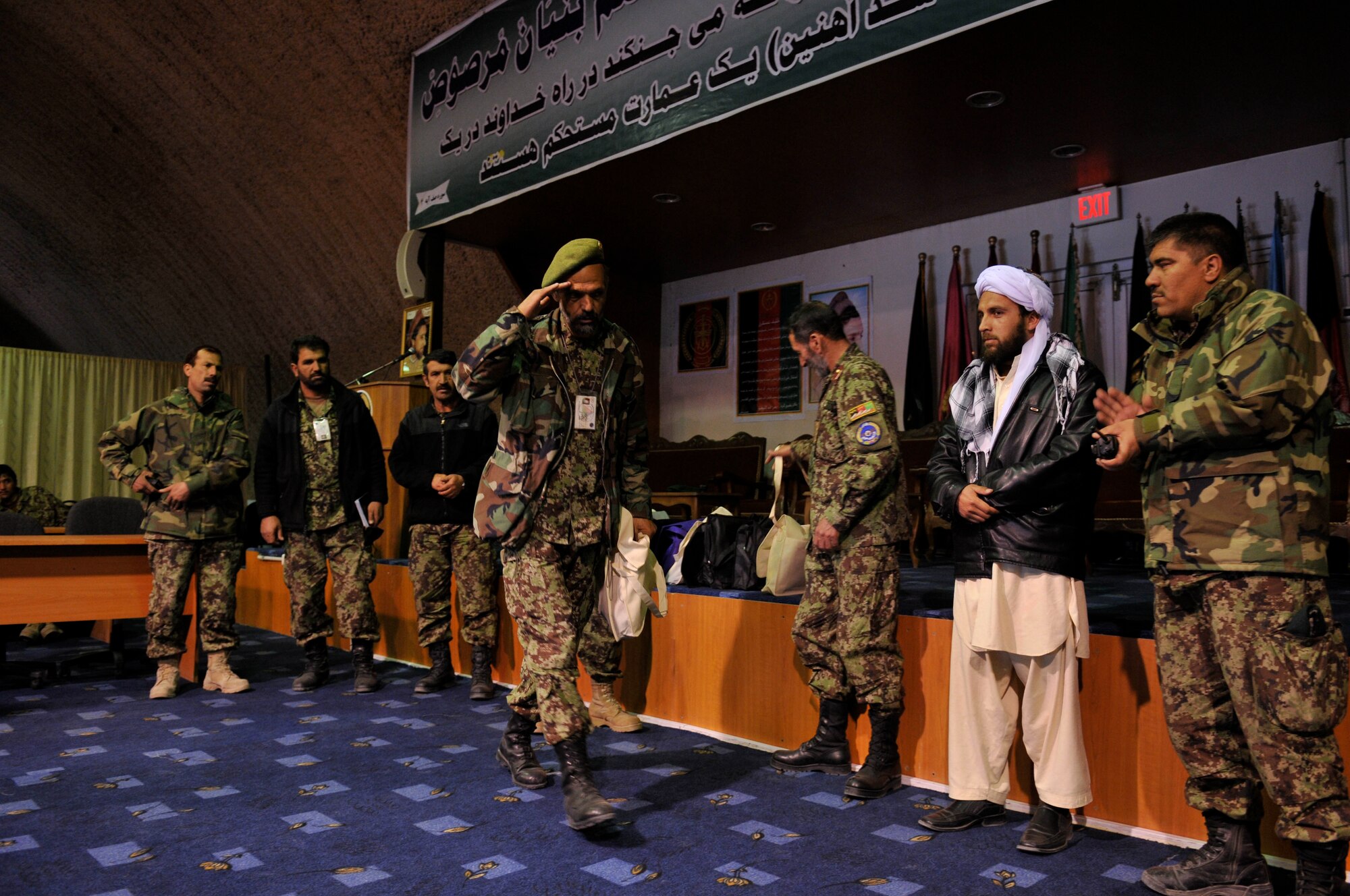 KABUL, Afghanistan - Afghan airman 
salutes his his superiors in the Afghan Air Force after receiving a gift given to him during a ceremony highlighting the hard work of Afghan airman at the Afghan Air Force base in Kabul, Afghanistan, March 19. (U.S. Air Force photo by Tech. Sgt. Brian E. Christiansen)