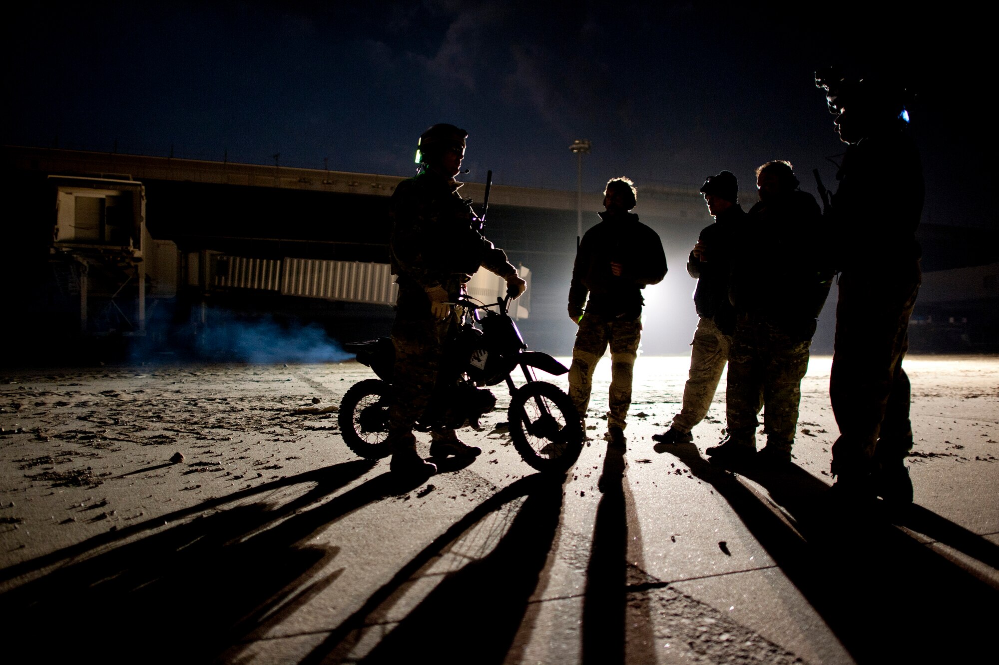 Maj. John Traxler (left), 320th Special Tactics Squadron commander, talks with members of his unit at Sendai Airport, Japan, March 19. The 320th STS currently manages the flightline at Sendai Airport, which was damaged after a March 11 earthquake and tsunami. (U.S. Air Force photo/Staff Sgt. Samuel Morse)