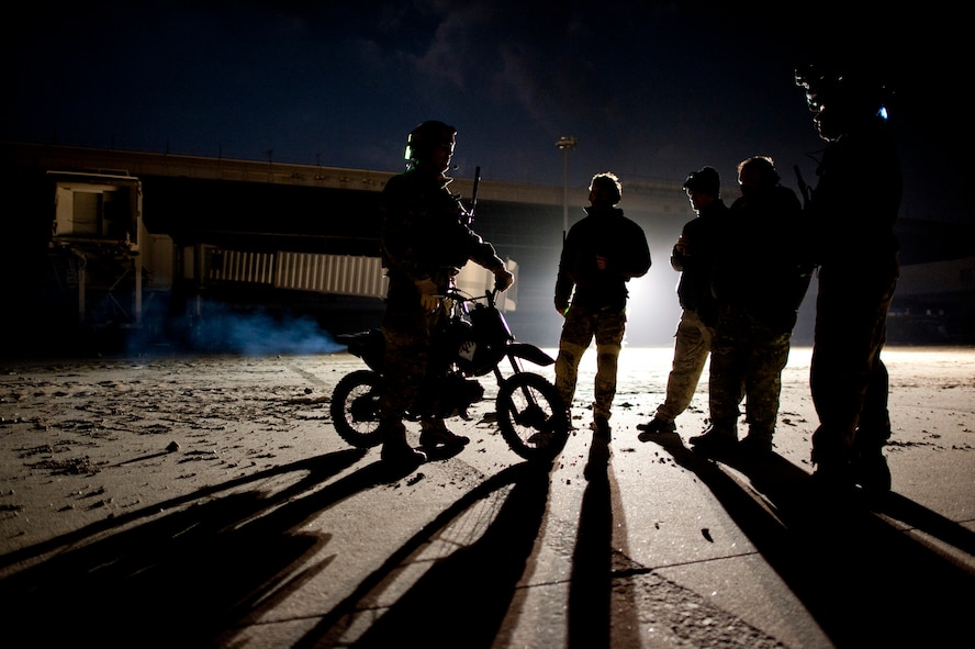 Maj. John Traxler (left), 320th Special Tactics Squadron commander, talks with members of his unit at Sendai Airport, Japan, March 19. The 320th STS currently manages the flightline at Sendai Airport, which was damaged after a March 11 earthquake and tsunami. (U.S. Air Force photo/Staff Sgt. Samuel Morse)