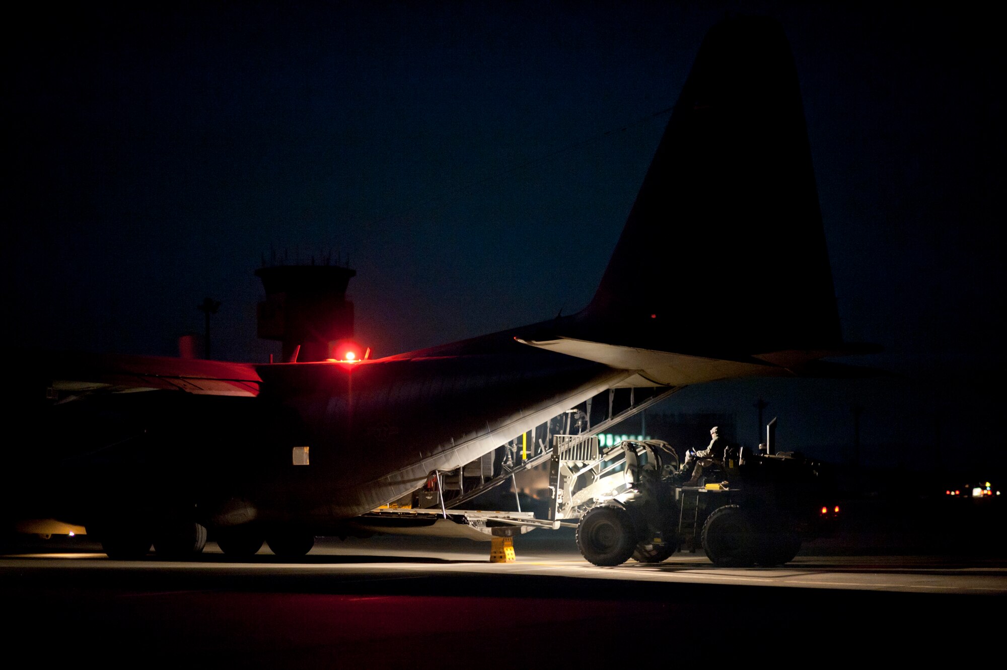 A forklift driver from the 353rd Special Operations Group unloads medical supplies from an MC-130P Combat Shadow at Sendai Airport, Japan, March 19. The 320th Special Tactics Squadron reopened Sendai Airport's runway to fixed-wing aircraft March 16, allowing supplies to be flown-in more rapidly to support Operation Tomodachi. The 320th STS is supporting U.S. military efforts to provide assistance to Japan following the March 11 earthquake and tsunami. (U.S. Air Force photo/Staff Sgt. Samuel Morse)