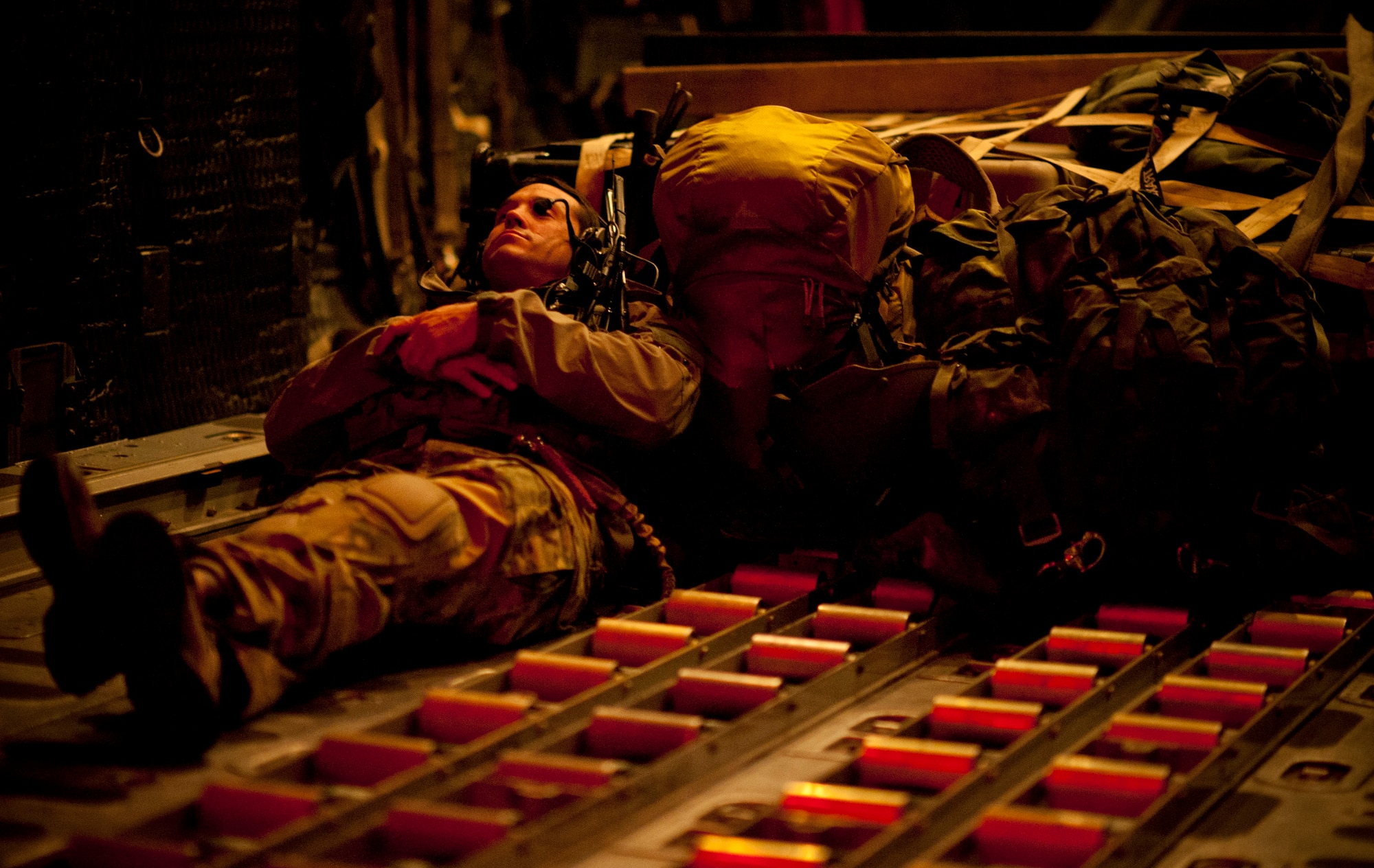 Tech. Sgt. Ray Decker, 320th Special Tactics Squadron special operations weather team, takes a nap on an MC-130P Combat Shadow bound for Sendai Airport March 19. The relatively small squadron currently manages Sendai Airport, meaning squadron members work long hours with little sleep, making downtime like this a welcomed break. The 320th STS is supporting U.S. military efforts to provide assistance to Japan following the March 11 earthquake and tsunami. (U.S. Air Force photo/Staff Sgt. Samuel Morse)