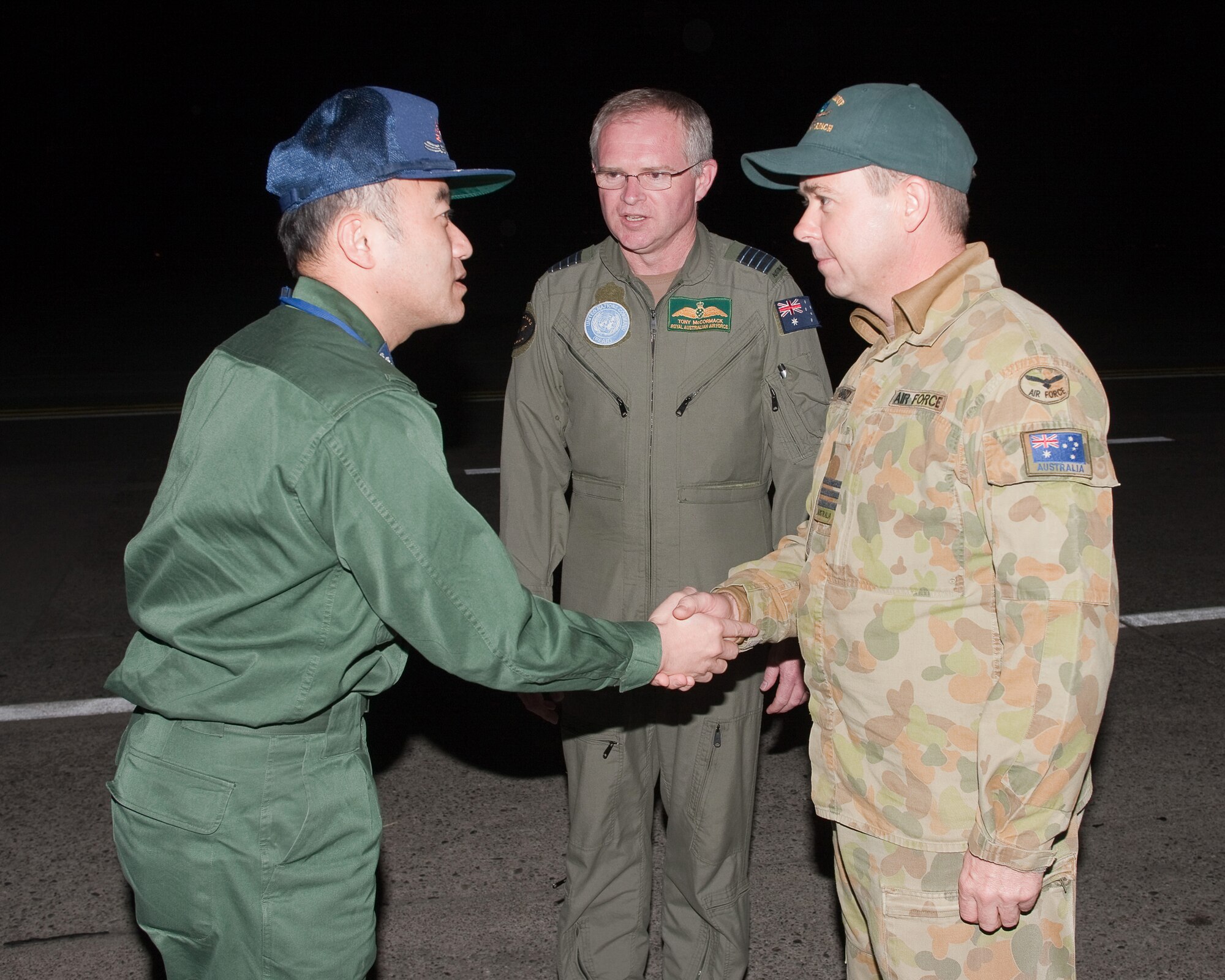 YOKOTA AIR BASE, Japan -- Col. Hiroyoshi Ooura (left), Japan Air Self-Defense Force Air Staff Office, extends his deep appreciation to Wing Commander David Howard (right), Royal Australian Air Force, for his unit's support during humanitarian relief operations following the earthquake and tsunami that struck Japan March 11. Amberley's 36th Squadron sent two RAAF air crews and a C-17 to Japan to fly numerous humanitarian missions. (U.S. Air Force photo/Osakabe Yasuo)