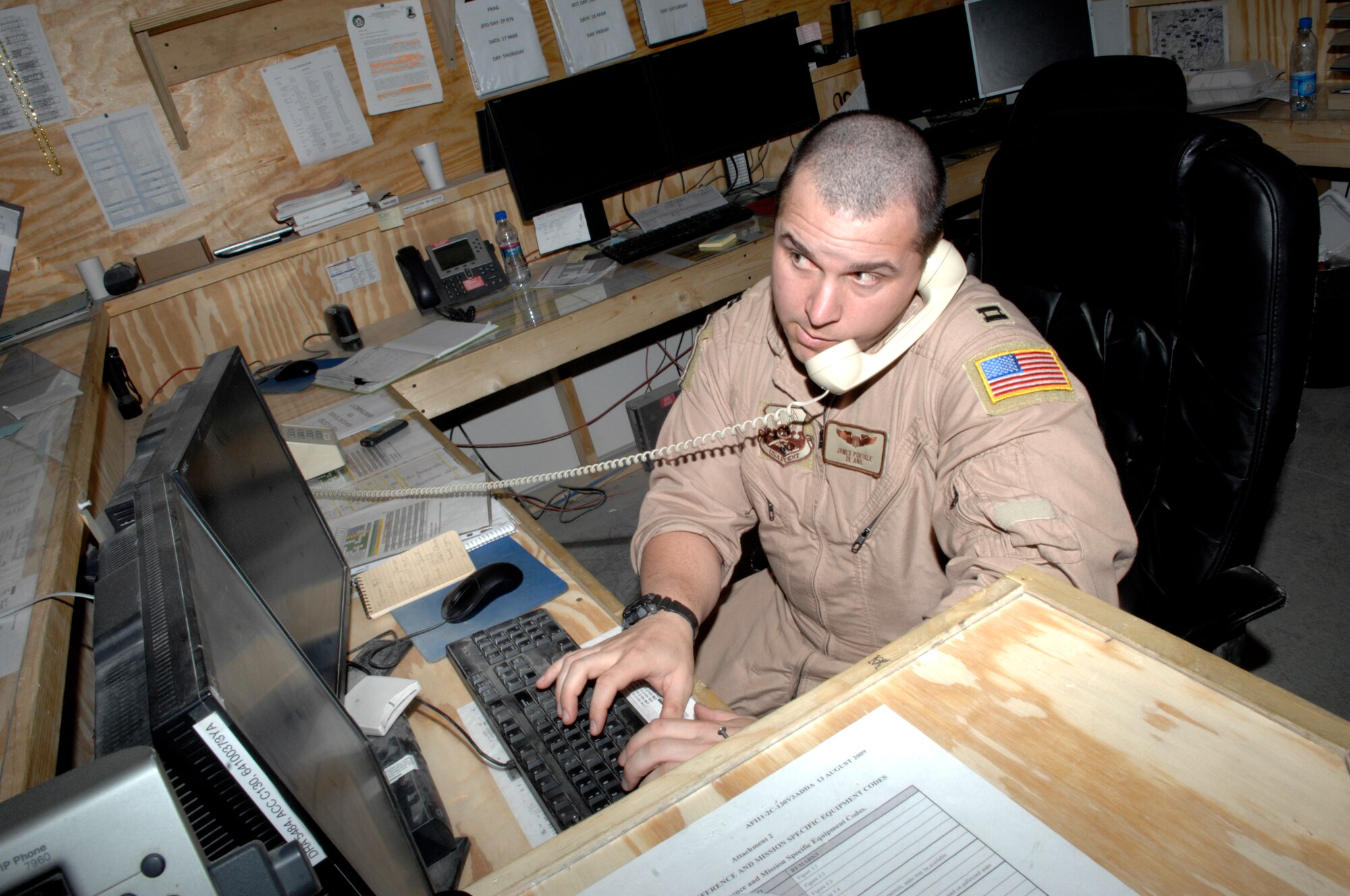 Capt. James Portale, 774th Expeditionary Airlift Squadron director of operations, works in what is referred to as the heart of the squadron because he tracks missions and talks to the pilots. Captain Portale is deployed from the 166th Airlift Wing, Delaware Air National Guard. (U.S. Air Force photo/Senior Airman Amber R. Kelly-Herard) 