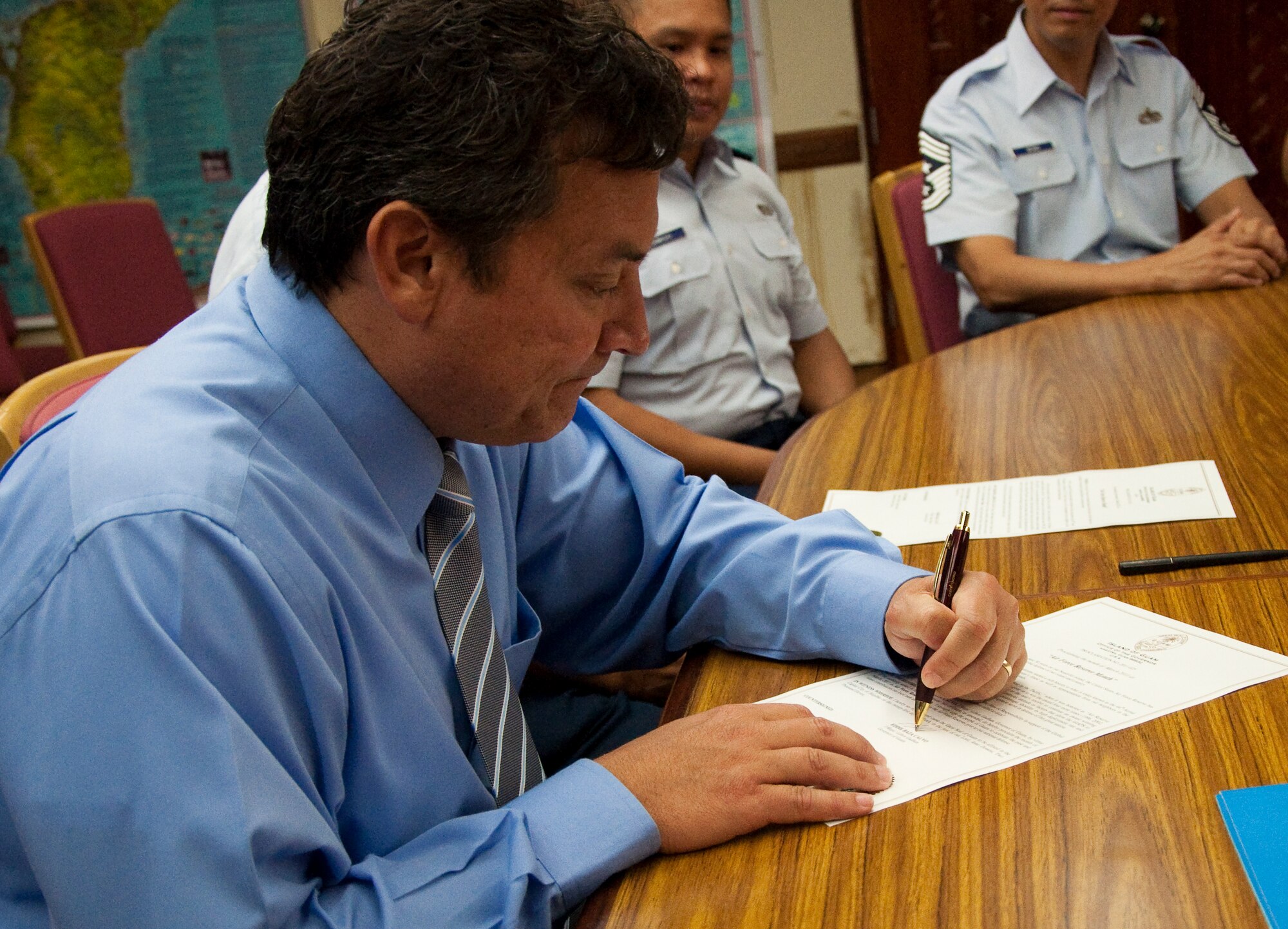 Gov. Edward B. Calvo, Guam governor signs a proclamation designating March as Month of the Air Force Reserve on Guam. The proclamation was signed on the 30th anniversary of the arrival of Air Force Reserve on Guam. U.S. Air Force Photo/Staff Sgt. Erin Smith