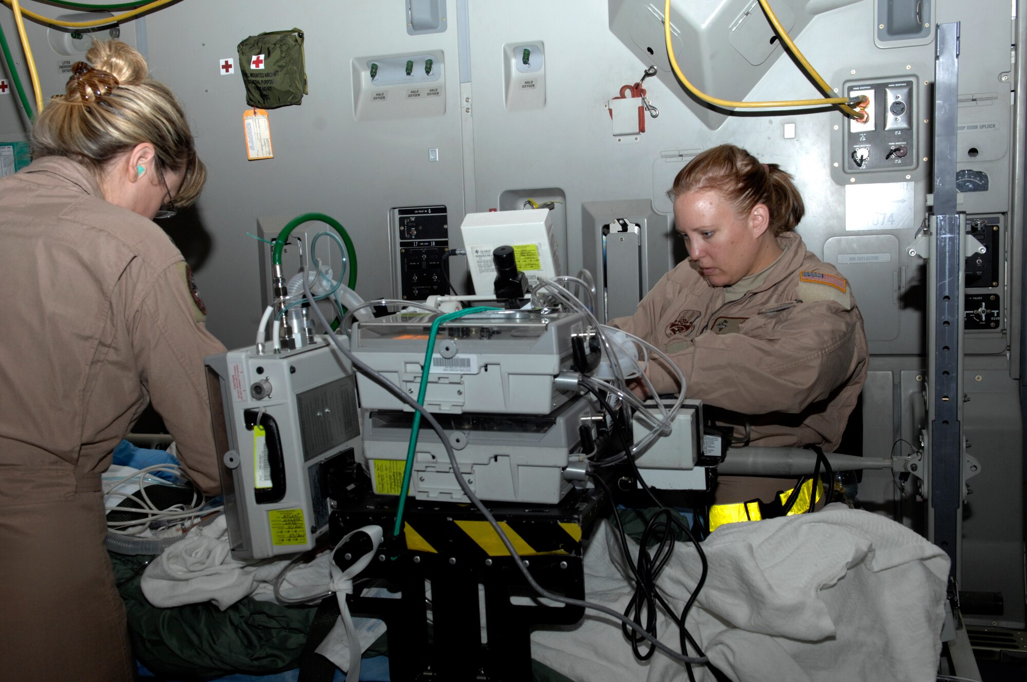 Capt. Jacquline Richards and Tech. Sgt. Bonnie McLauley, both members of a critical care team, transfer a patient from the Craig Joint Theater Hospital, Bagram Airfield, Afghanistan, to a plane enroute to Landstuhl Medical Center, Germany. The critical care team stays with a patient until they land at the hospital and transfer the patient's information to the receiving doctors. (U.S. Air Force photo/Senior Airman Amber R. Kelly-Herard) 