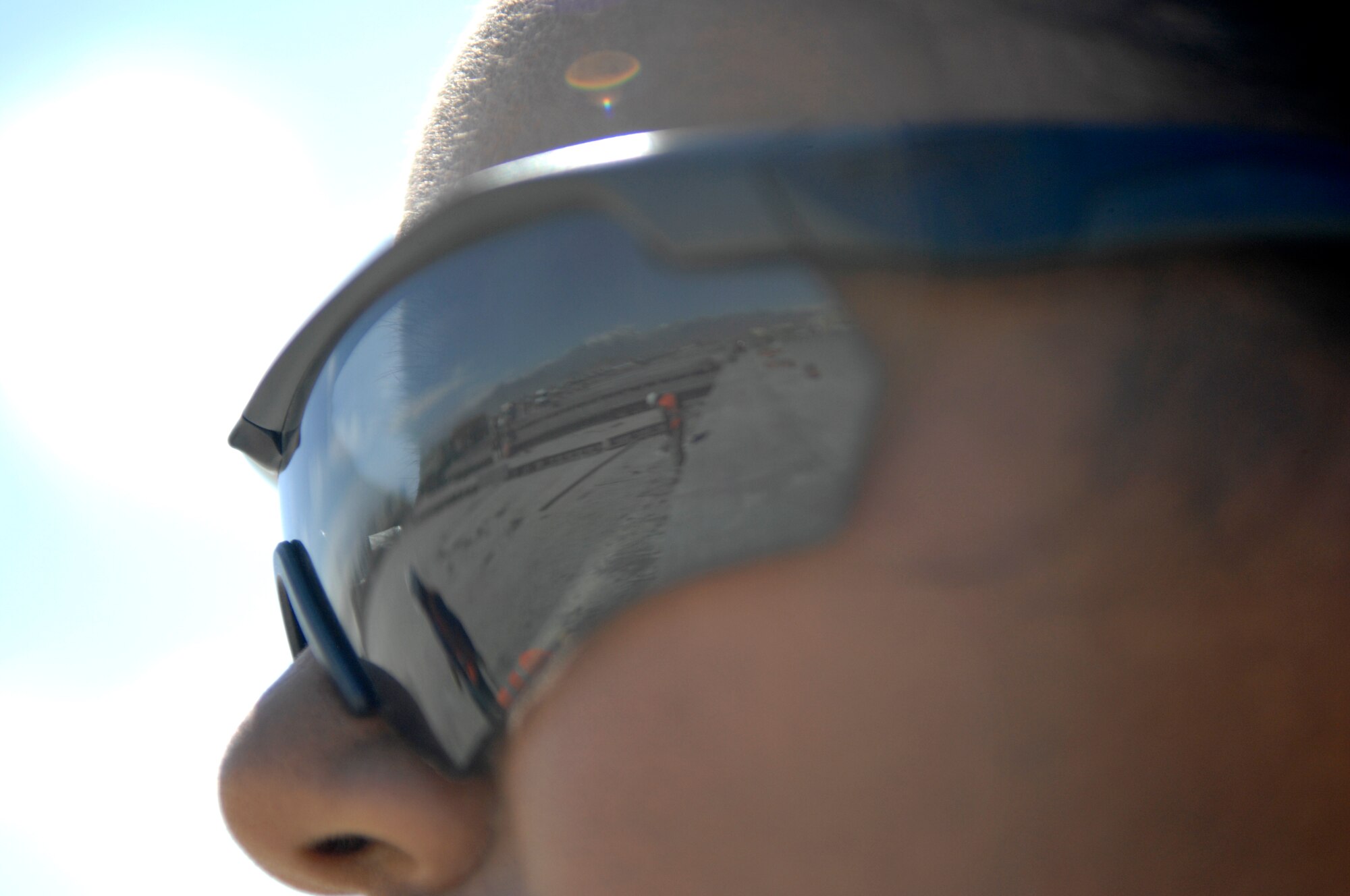 Airman 1st Class Shequita Sanchez, 455th Expeditionary Civil Engineer Squadron force protection guard, watches as third country nationals and local Afghan citizens conduct construction work on Bagram Airfield, Afghanistan. Airman Sanchez is deployed from the 375th Medical Operations Squadron at Scott Air Force Base, Ill. (U.S. Air Force photo/Senior Airman Sheila Devera) 