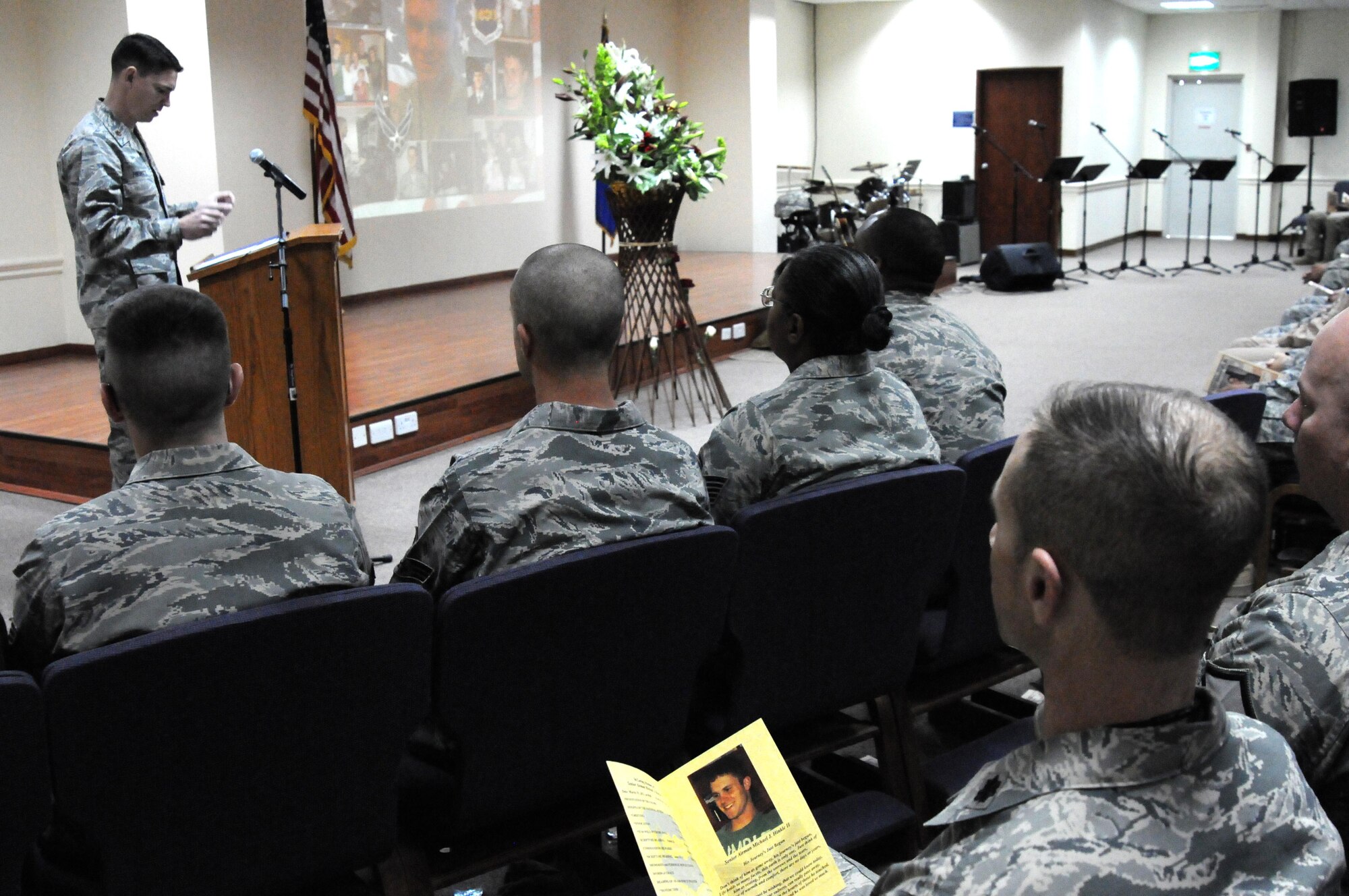Maj. James Hewitt, 386th Expeditionary Communications Squadron commander, speaks to the rest of the 386th Air Expeditionary Wing during a memorial service March 19 at an undisclosed location in Southwest Asia. The 386th AEW held a memorial to remember the life of Senior Airman Michael J. Hinkle II, 24, who died from a non-combat related incident March 16. (U.S. Air Force photo by Staff Sgt. Patrice Clarke)