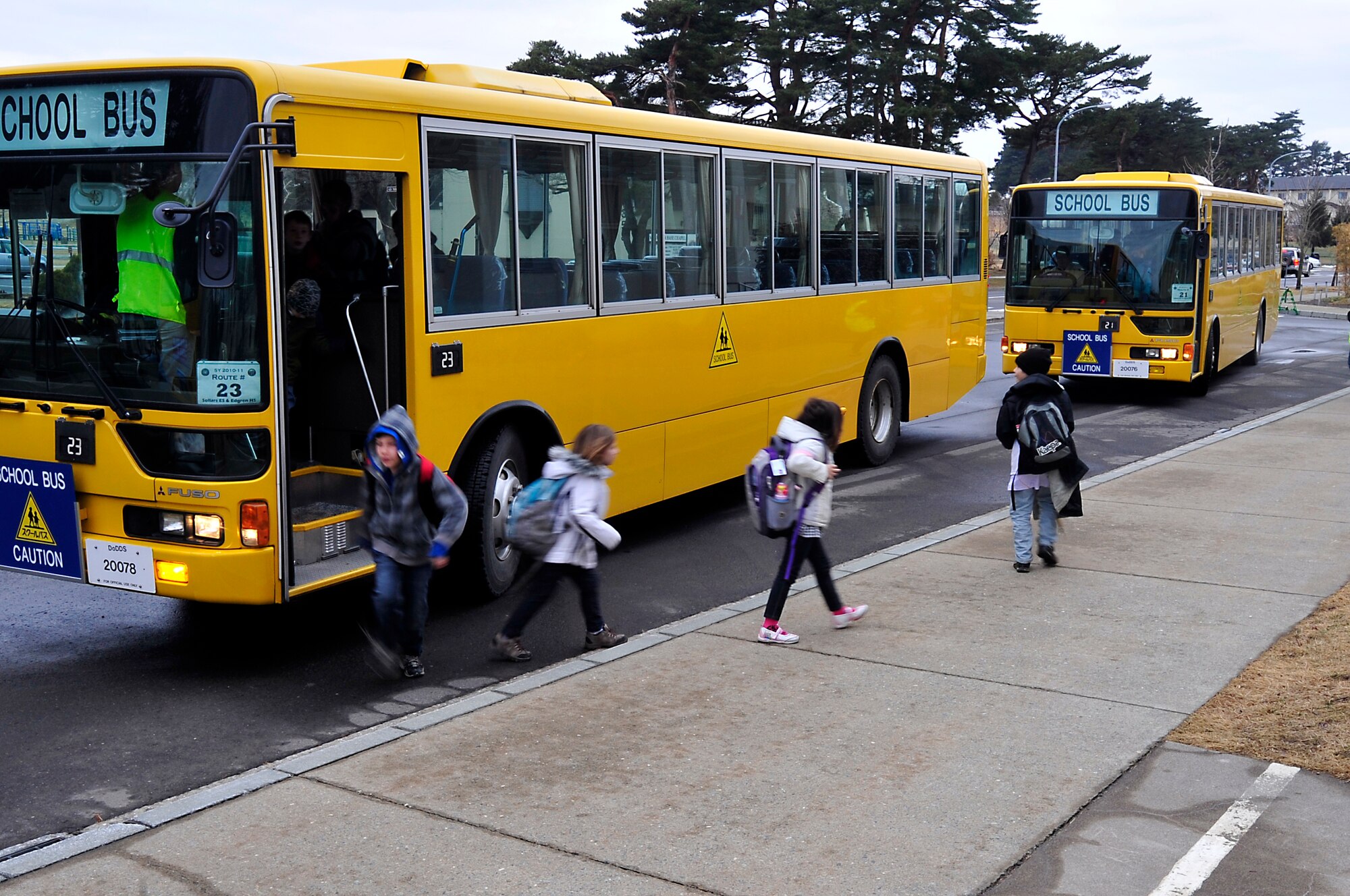 MISAWA AIR BASE, Japan -- Students step off school buses at Sollars Elementary Mar. 21. Base schools are back in session with all bus routes running and classes starting at the normal times. Students have been out since the school lost power after the earthquake that shook the northern coast of Japan Mar. 11. (U.S. Air Force photo by Staff Sgt. Marie Brown\Released)