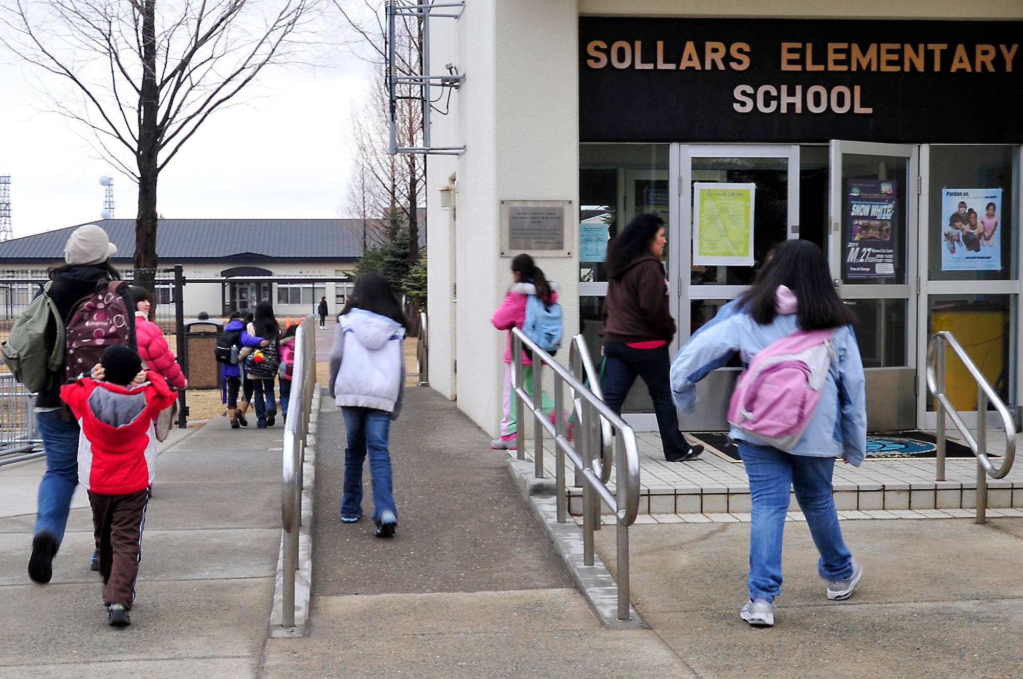 MISAWA AIR BASE, Japan -- Students at Sollars Elementary School walk to their respective classrooms Mar. 21. Base schools are back in session with all bus routes running and classes starting at the normal times. The schools were closed down for a week after power was knocked out due an earthquake that shook the northern coast of Japan Mar. 11. (U.S. Air Force photo by Staff Sgt. Marie Brown\Released)