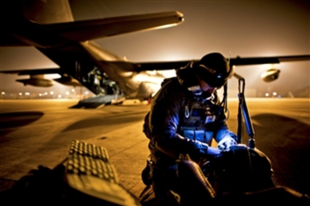 U.S. Air Force Tech. Sgt. Ray Decker prepares his rucksack before boarding an MC-130P Combat Shadow in Sendai, Japan, on March 16, 2011.  Decker is assigned to the 320th Special Tactics Squadron and deployed to Sendai Airport to help clear the runway and prepare it for fixed-wing aircraft traffic.  