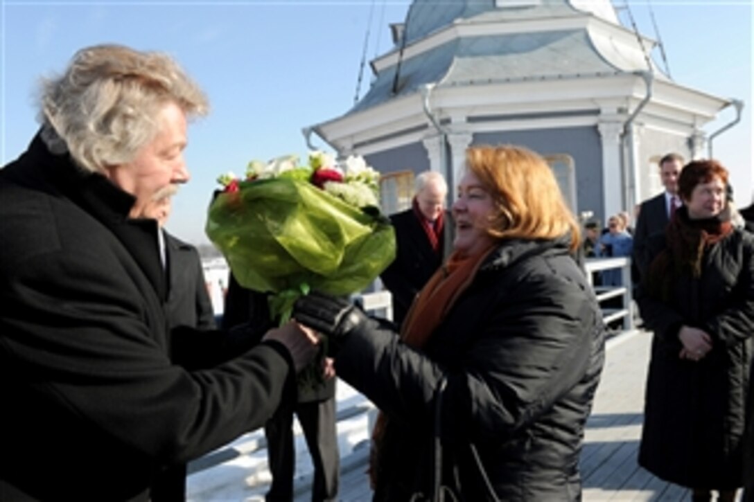 Becky Gates, wife of Secretary of Defense Robert M. Gates, receives flowers during a tour of the Peter and Paul Fortress in St. Petersburg, Russia, on March 21, 2011.  