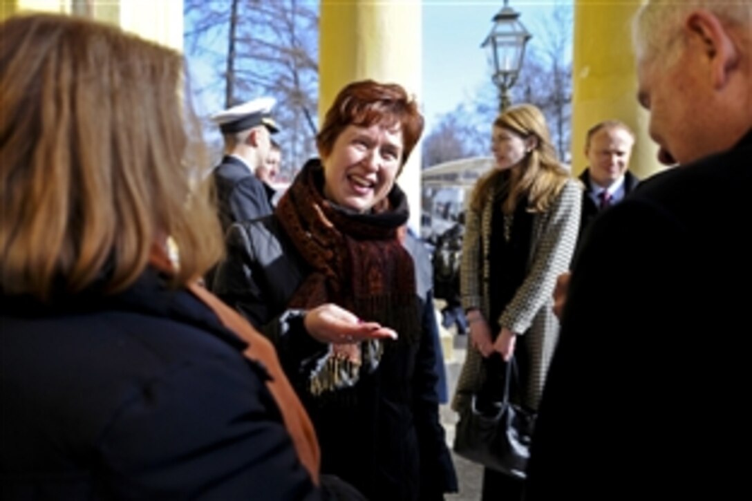 U.S. Defense Secretary Robert M. Gates, right foreground, and his wife, Becky, left foreground, thank their tour guide, center, by giving her a coin at the Peter and Paul Fortress in St. Petersburg, Russia, March 21, 2011.
