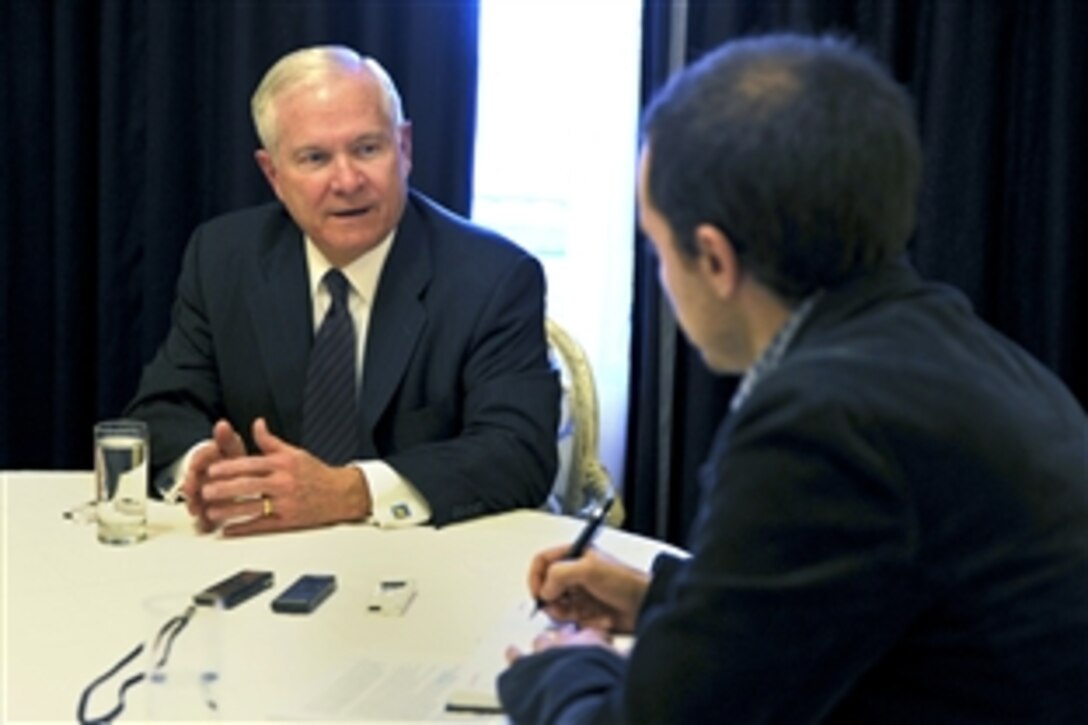 U.S. Defense Secretary Robert M. Gates, left, speaks with Interfax Group reporter Igor Slenznyov in St. Petersburg, Russia, March 21, 2011. Interfax Group is a leading provider of critical information on Russia, China and emerging markets of Eurasia.