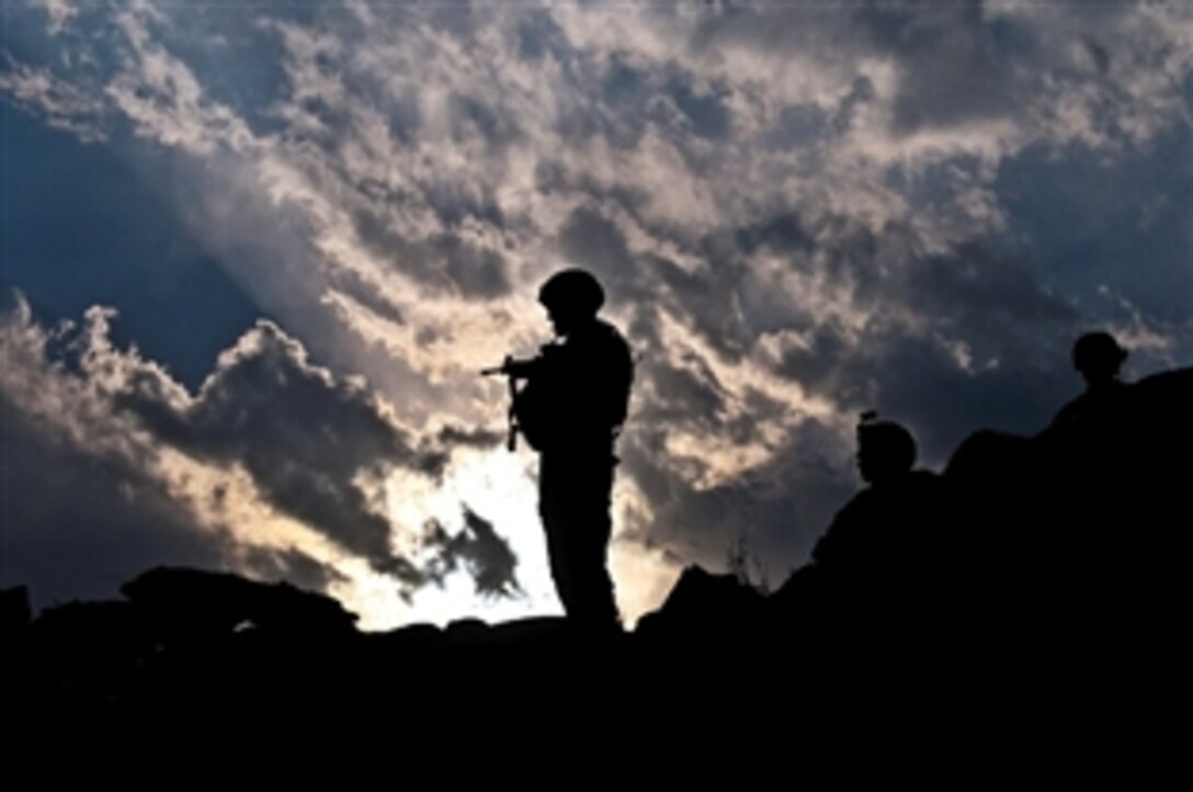 The sun sets behind U.S. Army Sgt. 1st Class Jamie R. Johnson, a platoon sergeant assigned to Bayonet Company, 2nd Battalion, 327th Infantry Regiment, Task Force No Slack, as he patrols Afghanistan's Kunar province, March 17, 2011.