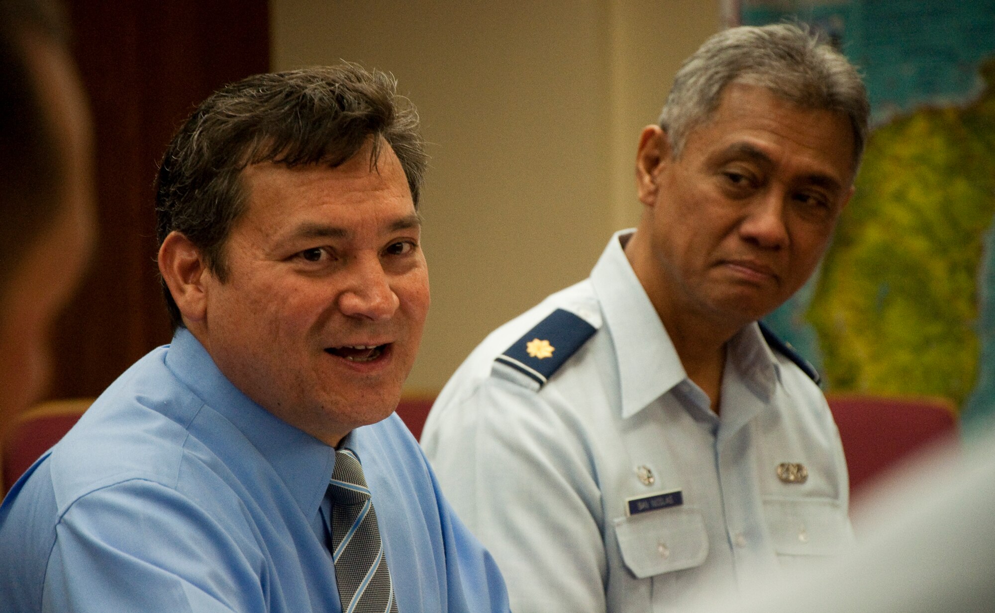 Gov. Edward B. Calvo, Guam Governor, and Maj. Anthony San Nicolas, 44th Aerial Port Squadron commander, talk with Airmen from the 44th APS and 735th Aeromedical Staging Flight, Mar. 21, before the governor signed the proclamation designating March as Month of the Air Force Reserve on Guam. March 21 is also the 30-year anniversary of the Air Force Reserve on Guam. U.S. Air Force Photo/Staff Sgt. Erin Smith