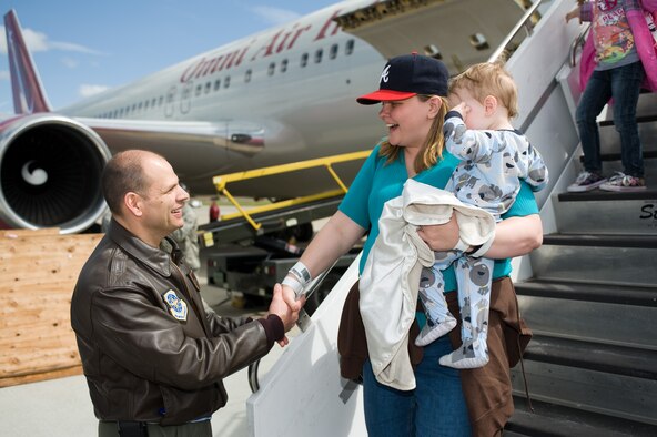 60th Air Mobility Wing commander Col. James Vechery welcomes Melissa Wilds and her children as they arrive at Travis AFB, Calif. Wilds and her children were part of approximately 240 military  family members who returned to the U.S. from Japan following the March 11, 2011 earthquake and tsunami that hit the island nation. Wilds' husband is in the U.S. Navy and stationed at Yokosuka Naval Base. (Photo by Ken Wright)