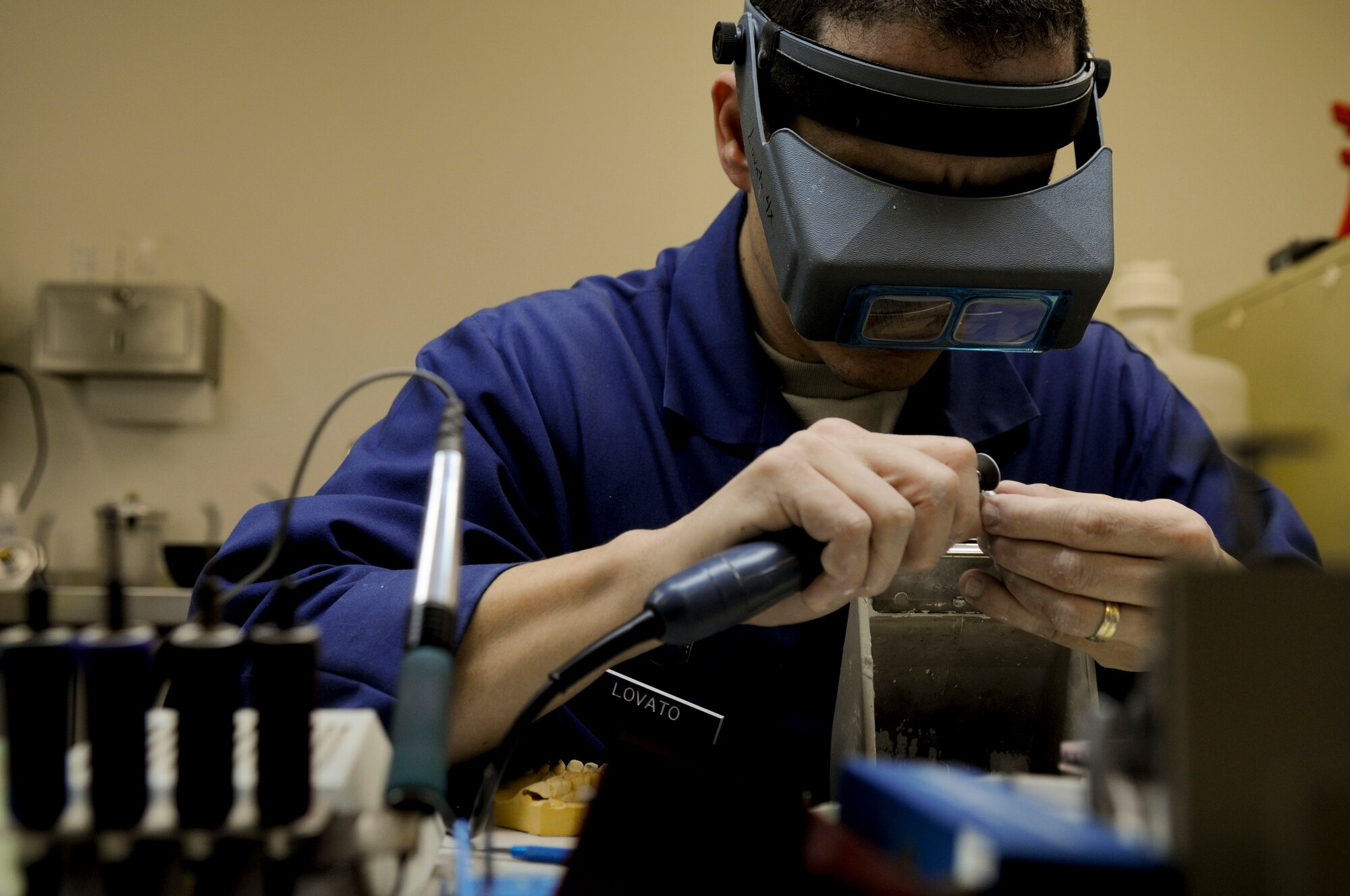 Tech. Sgt. Steve Lovato, a dental laboratory craftsman with the 18th Dental Squadron, fine tunes a crown to make sure it is smooth, at Kadena Air Base, March 10. Crowns are the most common thing the dental laboratory typically constructs.  (U.S. Air Force photo/Airmen 1st Class Brooke P. Beers)