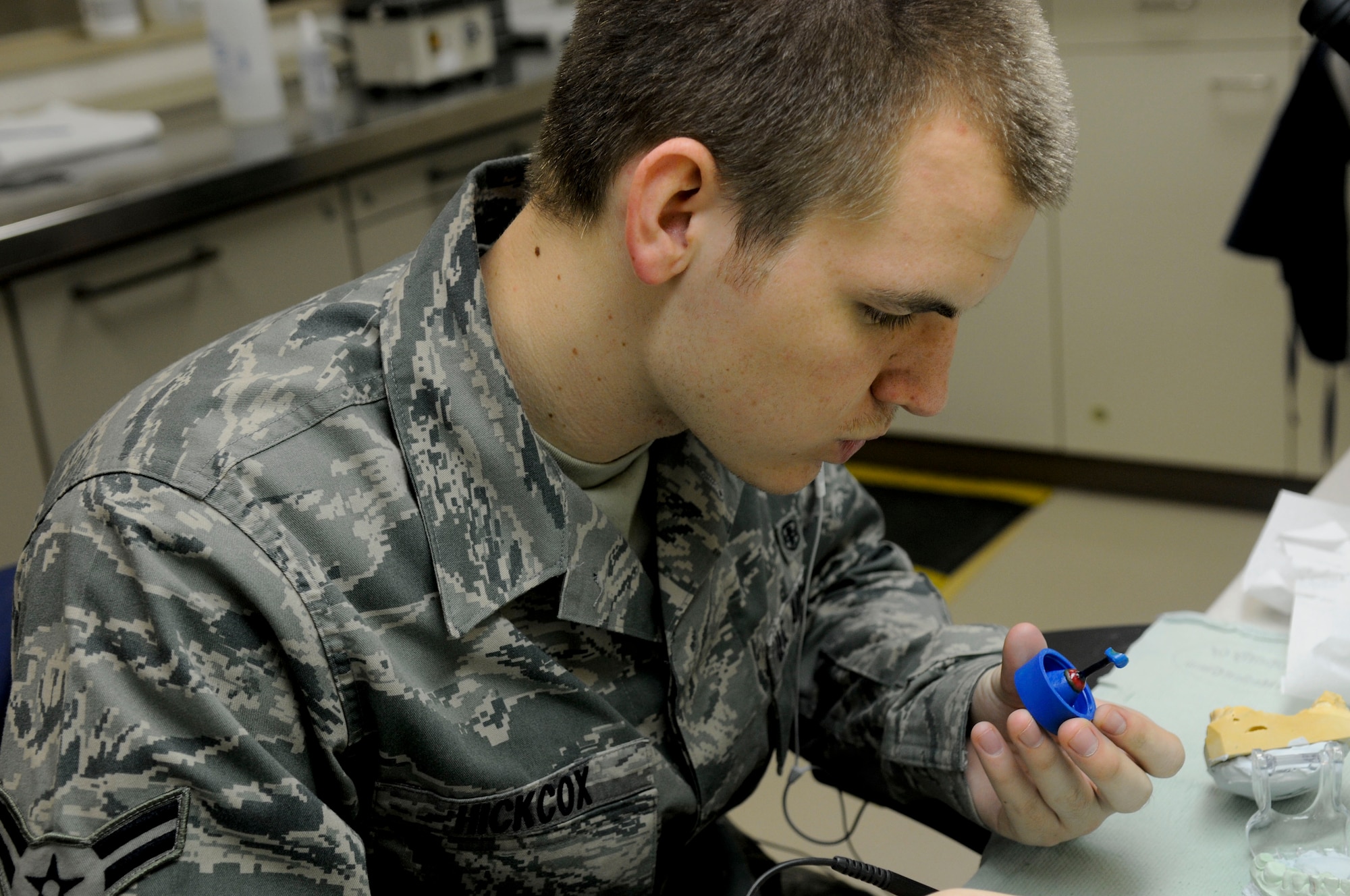 Airmen 1st Class Steven Hickcox, a dental laboratory technician with the 18th Dental Squadron, constructs a crown for a patient at Kadena Air Base, March 10. To create the crown, the technician creates a mold of wax then discharges gold into it, making the final product a strong and shiny crown. (U.S. Air Force photo/Airmen 1st Class Brooke P. Beers)