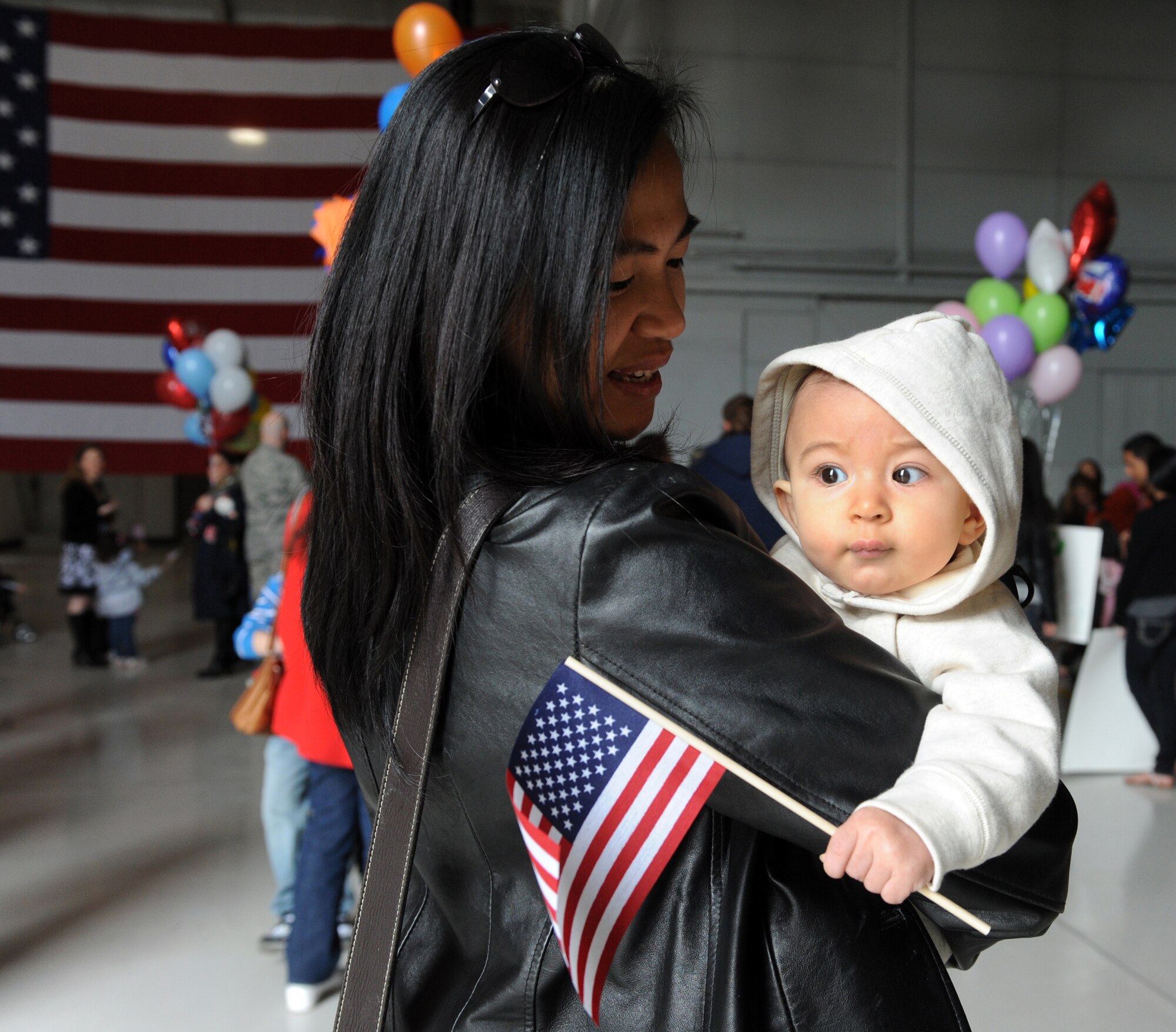 MOUNTAIN HOME AIR FORCE BASE, Idaho –Cynthia Zukauckas holds her daughter Mikayla while she waits in hangar 1331 for her husband, Tech Sgt. Michael Zukauckas to return from a deployment to Southwest Asia, March 19. Approximately 200 Airmen from the 726th Air Control Squadron returned from a deployment in support of Operation New Dawn. The 726th ACS has a strong support system in place for those family members left behind during a deployment. This gives deploying Airmen peace-of-mind knowing their families will be looked after so they can focus on their mission. (U.S. Air Force photo by Senior Airman Debbie Lockhart)