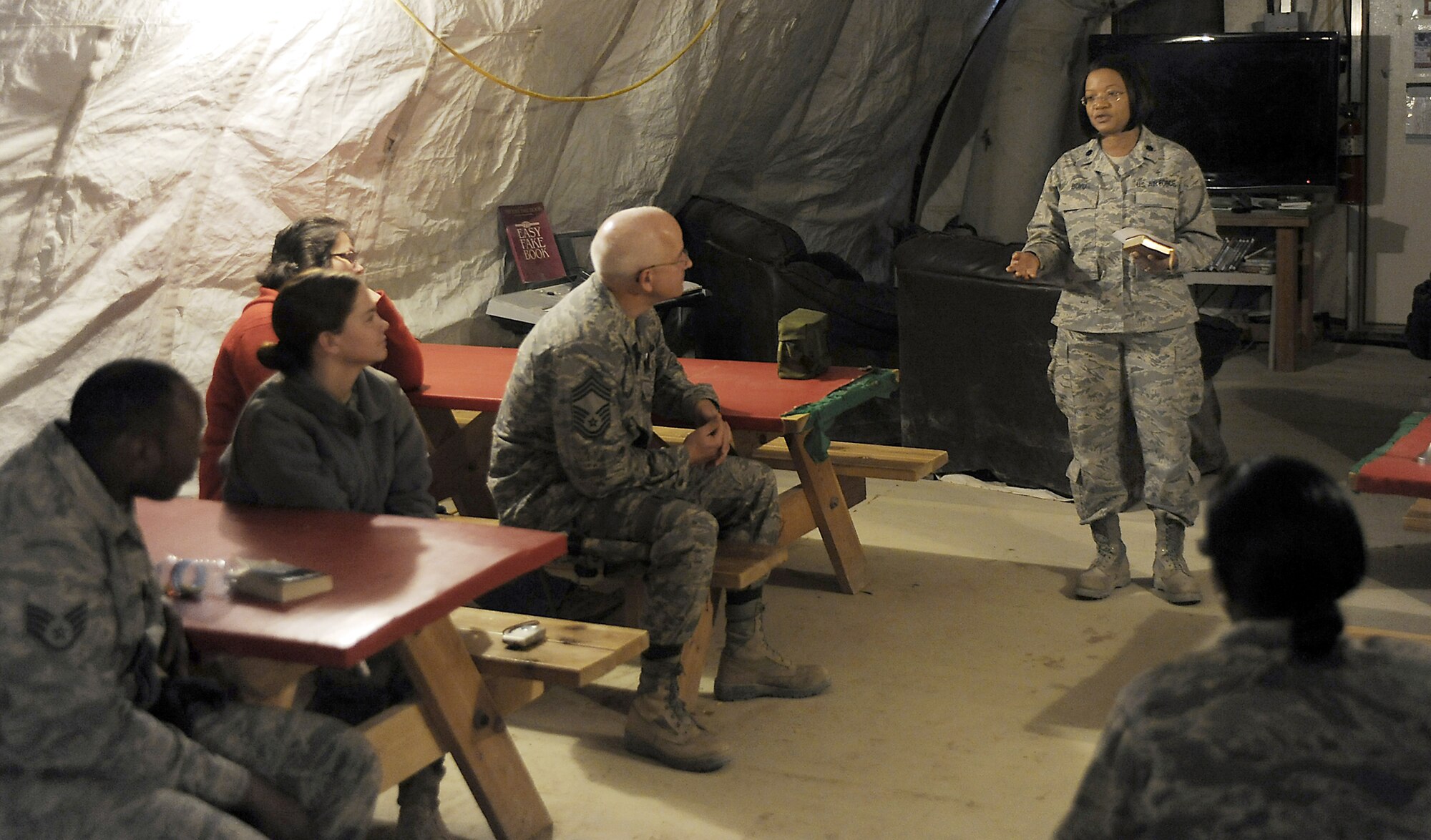 Chaplain (Lt. Col.) Donnette Boyd performs a 10-minute field service, March 12, 2011, at Kandahar Airfield, Afghanistan. Chaplain Boyd conducts these field services at three locations to maximize the number of Airmen she can reach. Chaplain Boyd is assigned to the 451st Air Expeditionary Wing. (U.S. Air Force photo/Senior Airman Willard E. Grande II)