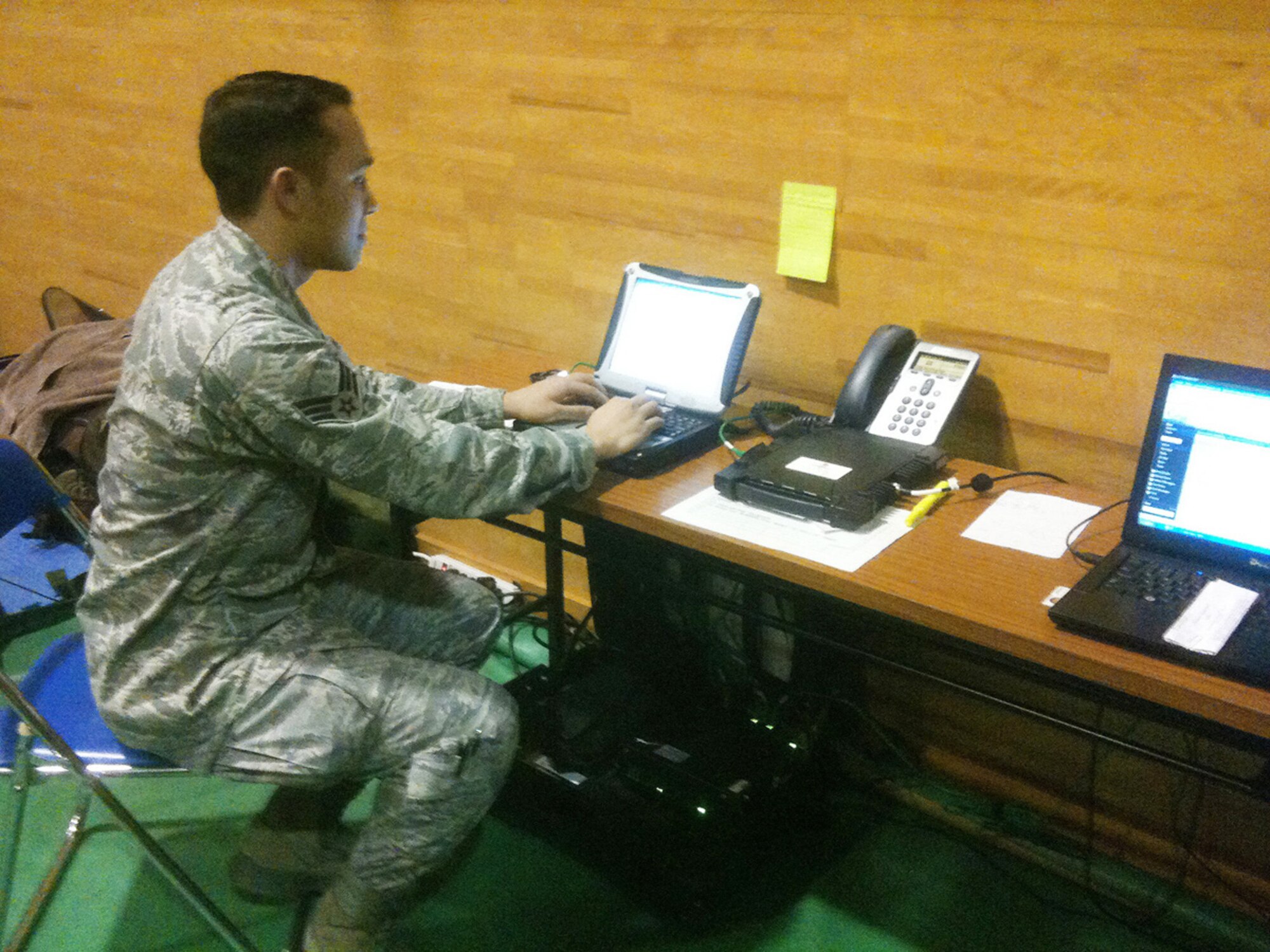 Senior Airman Adam Colby sets up a laptop to a special operations forces high-speed agile reachback kit March 20, 2011, at Yamagata Airport, Japan. The SHARK is a tactical communications kit capable of providing multiple security level voice, video and data regardless of IP input method. Airman Colby is providing the only communications support for more than 60 Marines from the 3rd Marine Expeditionary Force deployed manning a forward arming and refueling point here. Airman Colby is a special operations tactical communications specialist from the 353rd Special Operations Support Squadron. (Courtesy photo)