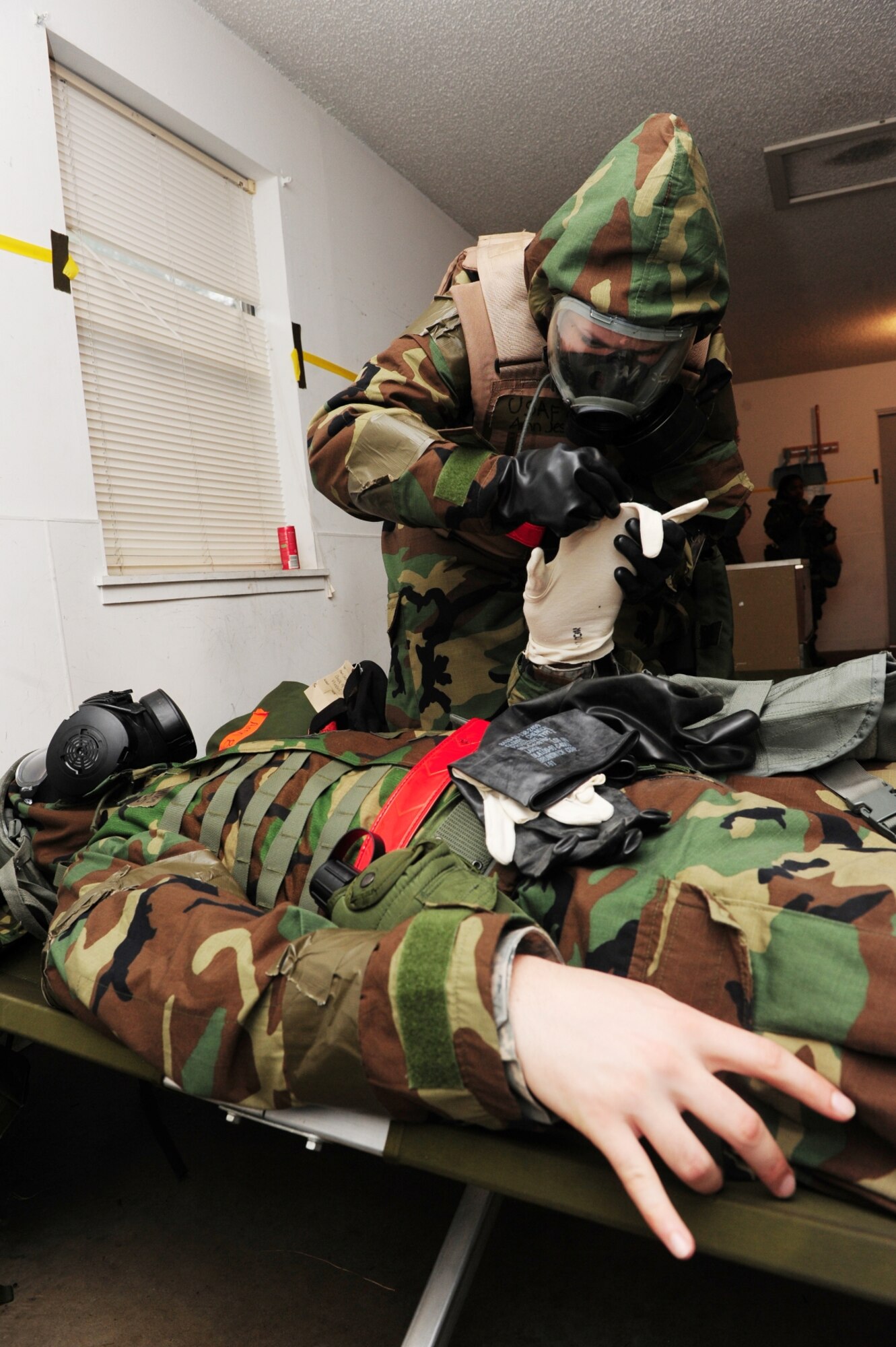 Airman Jessica Brown, 19th Medical Operations Squadron aeromedical space technician, performs self aid buddy care on Staff Sgt. Thomas Williams, 19th MDOS aeromedical space technician, during an exercise March 14, 2011 at Little Rock Air Force Base, Ark. (Photo by U.S. Air Force Senior Airman Jim Araos)