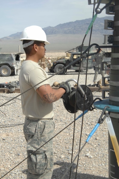NEVADA TEST AND TRAINING RANGE, Nev.-- Staff Sgt. Jimmy Mendizabal, 822nd Base Defense Squadron client services technician from Moody Air Force Base, Ga., works on taking down all communication equipment March 16, 2011, used during DESERT EAGLE. Airmen from the 822nd BDS and 1 Squadron Royal Air Force Regiment were able to talk with each other and the base defense operations center because of the 18,000 pounds of equipment brought by the communication division. (U.S. Air Force photo/Airman 1st Class Brigitte N. Brantley-Sisk)(RELEASED)